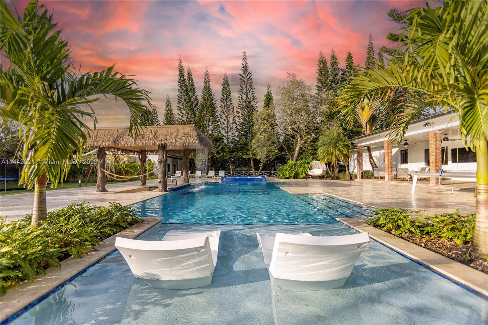 This state-of-the-art Mansion boasts the latest in design and technology. With an open-concept floor plan, the spacious living areas are filled with natural light and offer stunning views from the garden to the pool and much more! The gourmet kitchen features custom cabinetry, top-of-the-line appliances, and a large center island with a sleek Marble countertop. The master suite is a true retreat, complete with a luxurious spa-like bathroom and walk-in closet. Other highlights of this home include smart home technology, a home theater, and a saltwater pool with a built-in hot tub.House has $1M worth of upgrades and furniture. See attached the PDF explaining the HUGE INCOME this property is generating, this year projection is at the moment close to $500K and it has Potential for much more!