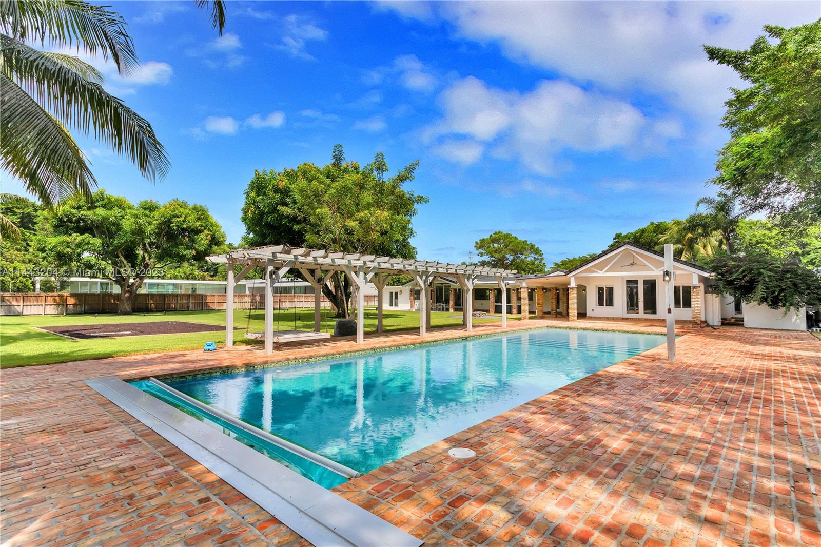 Discover modern luxury at 7800 SW 115th St in prestigious Pinecrest, FL. This extensively updated home boasts 5 bedrooms, each with its own ensuite bathroom, providing unparalleled comfort & privacy.  Spanning 5,141 adj SF, the residence offers large living spaces that merge elegance with function. A chef's kitchen is adorned with top-of-the-line appliances and custom Wenge wood cabinetry. The connected living, dining & family rooms overlook a large covered patio through enormous impact windows & doors. With a sprawling 39,204 SF lot enveloped by large lawn and fruit trees, the outdoor space is a private oasis, the inviting pool is surrounded by a landscape that offers a serene backdrop.  Embrace the serenity of this prime location while enjoying convenient access to urban amenities.
