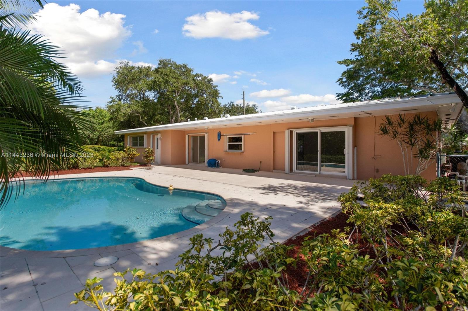 Wonderfully maintained light and bright 3 bedroom 2 bath home centrally located in Palmetto Bay.  Large corner lot with private fenced back yard. Light Metal roof 10yrs. Front door impact glass. Large rooms with easy flow great for entertaining. Family room with custom built in cabinets magnificent for extra storage. Updated kitchen including light wood cabinets up to ceiling, stainless steel appliances, and granite counters overlooking pristine pool and patio area. Indoor laundry. Freshly painted interior. Neutral tile, terrazo, and carpet flooring. Walking distance to Coral reef school and park. Close to great shopping, schools, dining, Deering Estate, Thalatta, Library, and bike path. Brand new electrical panel installed September 2023. Gas line into the home for stove and dryer.