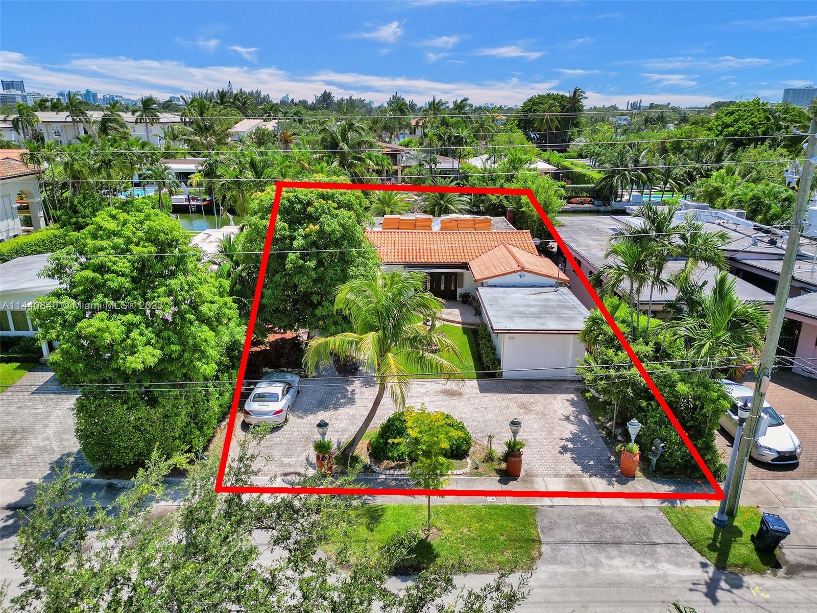 Unbelievably sought after Biscayne Point 60 ft waterfront smart home with 9ft ceilings, boatlift and only 1 bridge to the bay & ocean! Mid-Century Villa meets Moroccan Mosaic flair! Over $500K in renovations include impact windows, Bamboo kitchen, all 4 ensuite baths, full home theater projection & sound system, porcelain & field stone floors, custom solid wood doors, & electrical hurricane shutters, sprinklers & up lighting. Entertainers delight in your tropical oasis with covered tiki hut for 10 people, dining table, outdoor summer kitchen with BBQ, pizza oven. Investors will love the studio efficiency rented at $1,800 per month or use it as a guest, in-law or teenager suite! Brand new roof being installed with the potential to add 1250 sft of rooftop pleasure! All furniture negotiable.