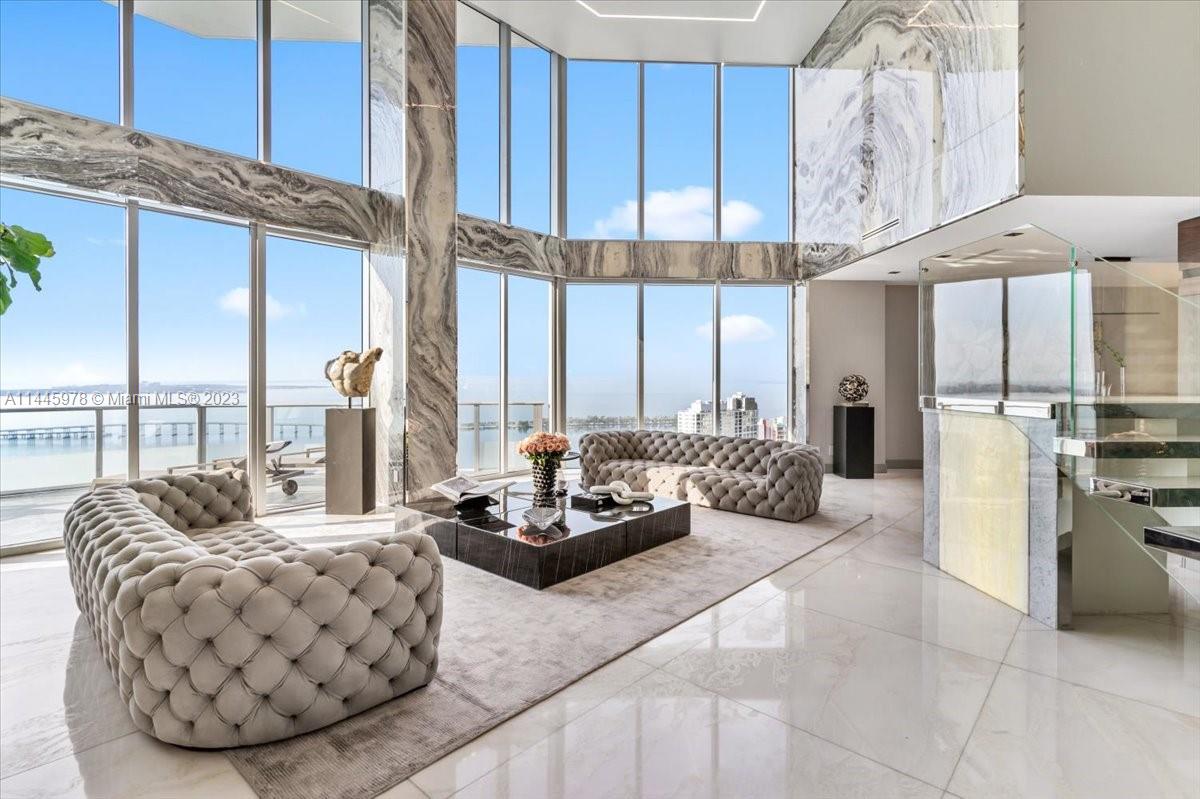 Welcome to the epitome of luxury living at the most exquisite penthouse in Brickell. This modern masterpiece has just hit the market, offering an unparalleled living experience across a staggering 7,000 square feet of harmonious space. With its impeccable design, soaring 20-foot high ceilings, and opulent features like Spanish white marble and custom-crafted onyx walls, this penthouse is a true work of art. Prepare to be captivated by the Marretti-designed living stairs, a testament to Milanese craftsmanship. With awe-inspiring open water views of Biscayne Bay, this penthouse is a private oasis that will leave you breathless.