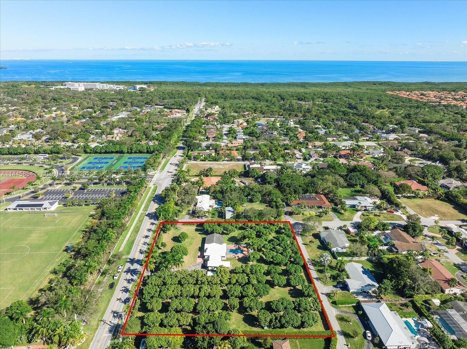 Rare opportunity to own a highly desirable location with an oversized 2.28 acre lot in Cutler Bay. Close to Old
Cutler Rd & minutes from Palmer Trinity School. Opportunity to make new construction or subdivide it for more
opportunities! Home has agricultural tax credit, meaning very low annual taxes. Abundant 100+ fruit trees. Main home is 2,635 sqft featuring 4bds/3bath at one end & kitchen, living space & den on the other. The large 36x20 pool is surrounded by a concrete pad, perfect for family gatherings. Adjoined to the home by the 2 car carport is an office with a full bath & gym space. This could easily become a guest home or rental. Last structure is a workshop & a pump house for well water. Home connected to a septic tank. This is a rare & unique opportunity that will not last!