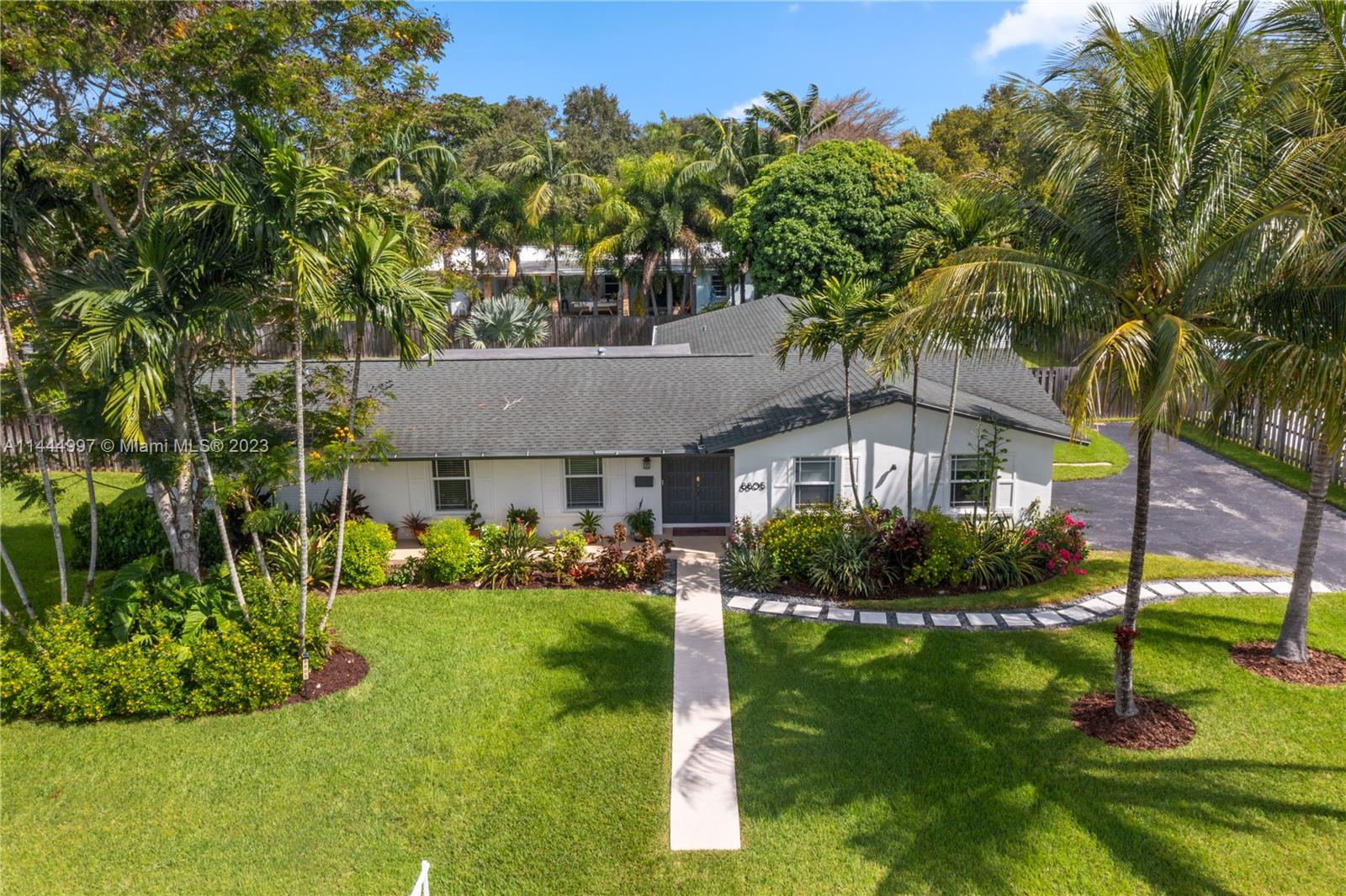 In the heart of Palmetto Bay find this beautifully maintained and landscaped residence. It has a split floor plan with 4-bedrooms and 2-bathrooms. The kitchen has been updated with wood cabinets and granite countertops. The property features impact glass windows and doors throughout (with the exception of the front door and garage door), ensuring the utmost security and energy efficiency. Plus, all pipes have been upgraded to PVC, the roof was replaced in 2018. In addition, new A/C ducts were installed in 2021, and a new A/C. There's a separate laundry room and a spacious 2-car garage. The outdoor patio space offers generous cover for entertaining. The pool has recently been resurfaced and also has a hot tub. Surrounded by a wood fence, your private oasis is enveloped by lush fruit trees.