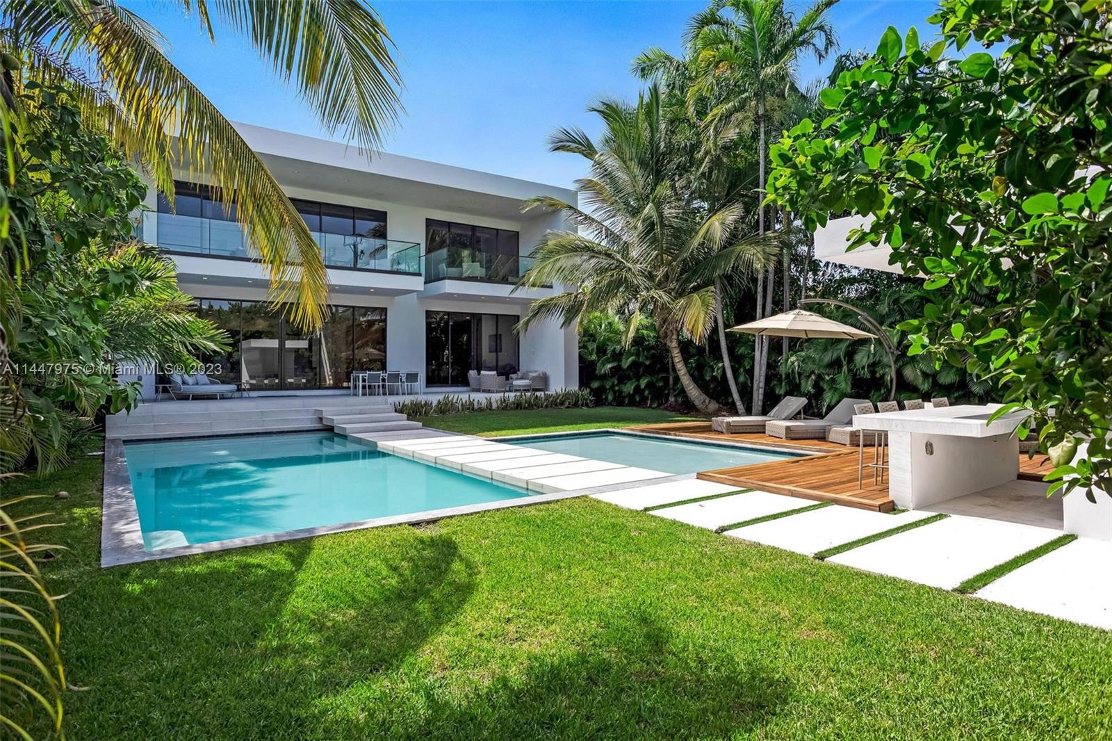 BRAND NEW TROPICAL MODERN VILLA ON PRESTIGIOUS MIAMI BEACH GOLF COURSE WITH GORGEOUS SUNSET VIEWS! Generous 10,400 SF LOT w/ 5 Bedrooms + 6 Baths encompassing 5,301 Adj Gross SF. Seamless Indoor/Outdoor Living Spaces + 11 FT High Ceilings Wrapped in Walls of Glass for Natural Light. Chef’s Eat-in Kitchen w/ Stainless Steel Appliances + Wine Refrigerator. Black Matte European Lighting t/o. Expansive Master Suite w/ Huge Terrace Overlooking Pool + Large Walk-in Master Closet wrapped in Marble & Oakwood. Master Bath has Freestanding Tub & Floating Double Vanity. Entertain Outdoors by Large Pool, Deck + Bar. Enjoy Magical Sunset Views from Private Rooftop Deck over the Miami Beach Golf Course. 2 car Garage w/ space for Lifts to fit 4 cars