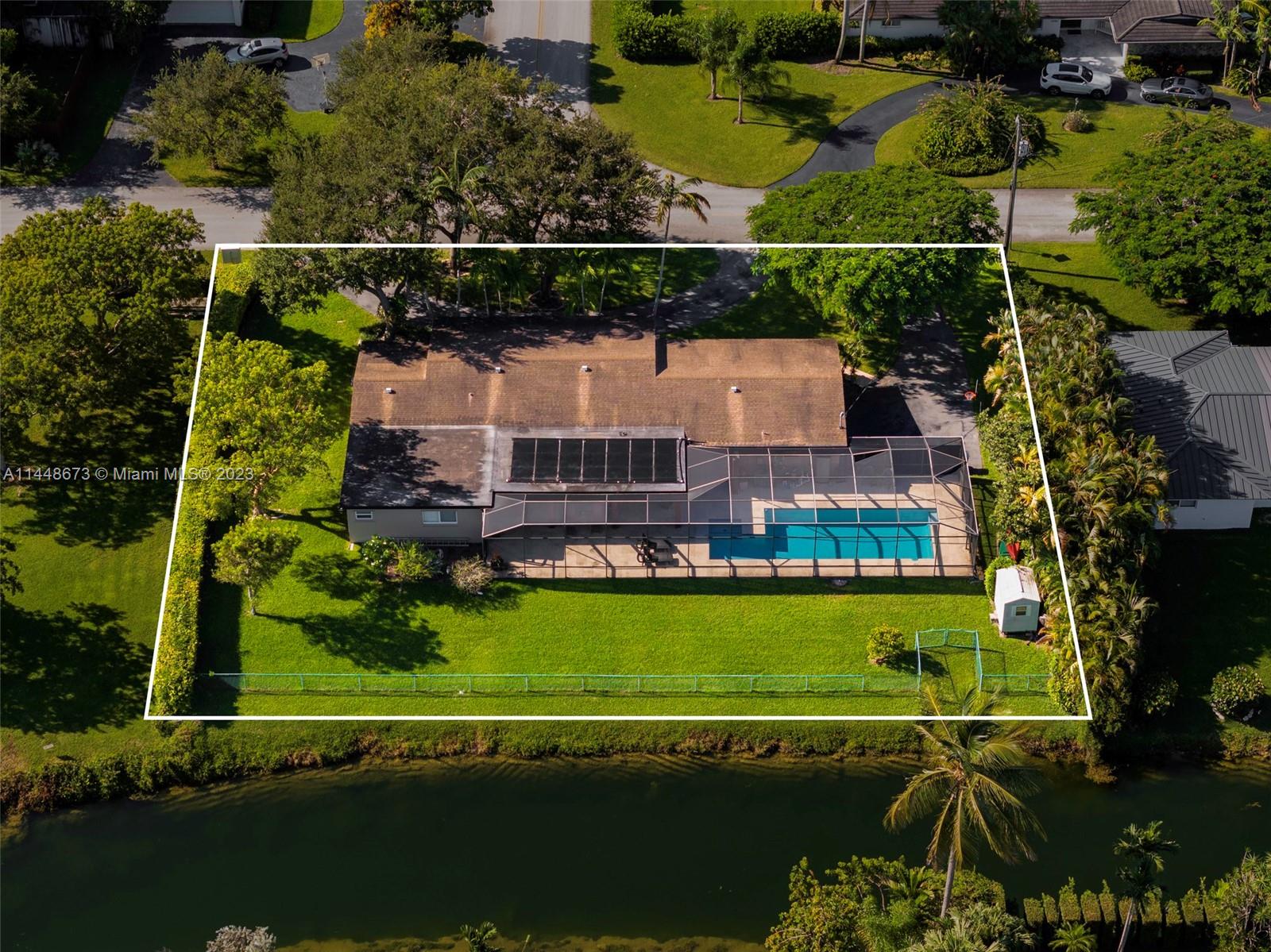 In the sought-after Pinecrest estate on a large motorized lake! It provides residents with picturesque water views, creating a serene and calming atmosphere. Four bedrooms, two baths, an oversized pool, a covered terrace, and a spacious yard create an ideal setting for outdoor entertainment. The garage is a valuable addition for parking and storage. Impact Windows through the house. Having a lake at your doorstep opens up various recreational opportunities, from boating and fishing to kayaking and paddle boarding.