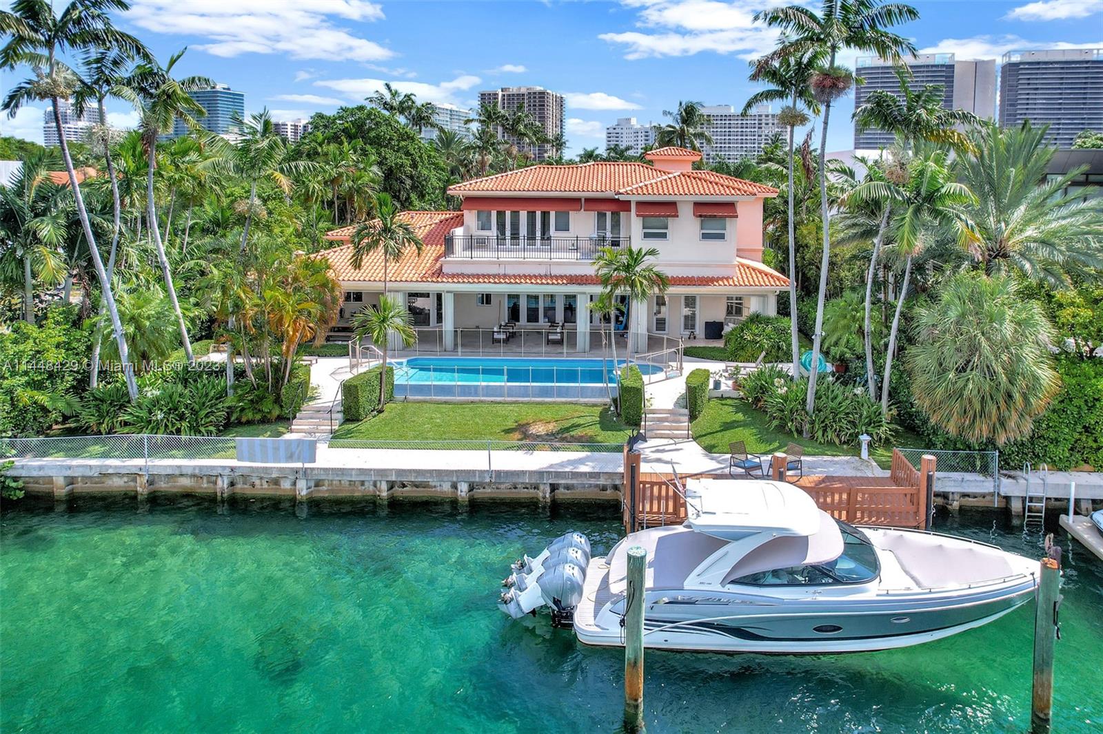 Palatial Mediterranean Estate almost half an Acre of Land on the water. Unique opportunity to purchase the lowest priced waterfront property in the exclusive guard gated community of Bal Harbour Village. This home sits on a spectacular 20,000+ square foot lot with 77 ft. of prime water frontage. Built in 2001; this incredible residence offers 4 Bedrooms, 6 bathrooms + detached 2 car garage and extremely rare full guest house suite. Additional features include library, office, patio, pool, jacuzzi, summer kitchen, garden, waterfront deck and more. Modernize this unique property and make it your dream home! Walking distance to the Bal Harbour Shops, 5-Star hotels, Beaches, Houses of Worship and much more.