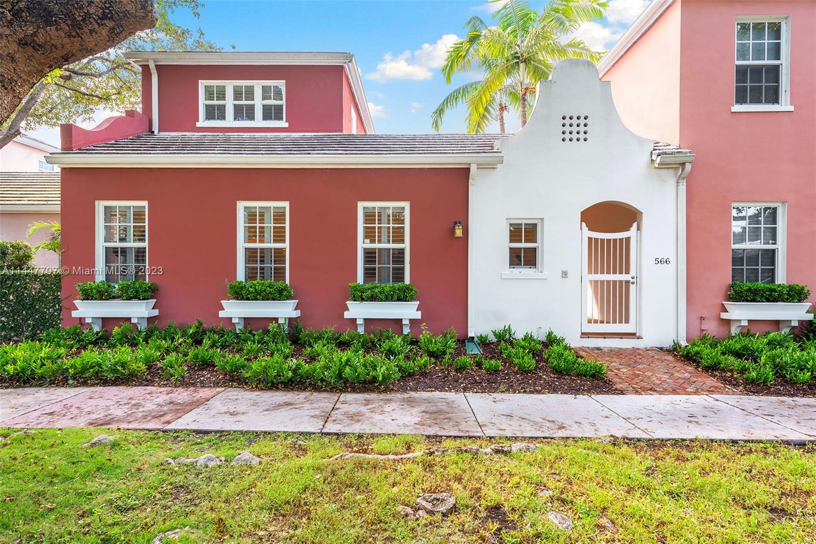 Crafted in the spirit of George Merrick's famous exotically themed Gables neighborhoods this tropical Bermuda style modern townhome delivers serene private courtyard-style living on a quiet tree-lined street with the convenience and desirability of a central Gables location. Through the front gate a lush private courtyard leads to a formal foyer entrance & sunlit great room w/ volume ceilings. From there a stunning marble kitchen, formal dining room, & 1st floor primary suite w/ luxe marble bath, 2 en-suite beds upstairs+bonus office space. 2-car garage with ample built-in storage, alarm system, wine fridge, stylishly chic new floors, California Closets throughout. Walk to Merrick Park, minutes from downtown Coral Gables, Coconut Grove, & South Miami. Rare chance to own in Bermuda Village!