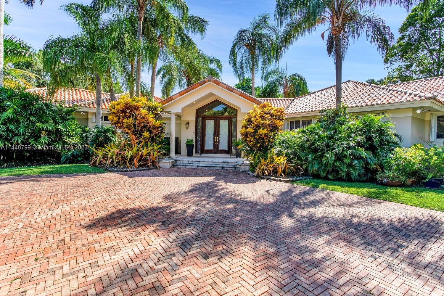 Imposing and elegant custom gated estate on one of the most desirable north Pinecrest streets, situated on private cul-de-sac. Lush acre laden with oak and tropical plantings. Unique architectural design of an excellent open flow floor plan, luxury finishes thruout, features vaulted ceiling, marble & wood flooring. Oversized picture windows, sunlit drenched interiors. Formal living and dining rooms lead to beautiful and expansive family room. gorgeous and updated gourmet dream kitchen centered around an expansive island equipped w/ top of line appliances and breakfast area. Magnificent grounds, sparkling large pool/spa. Roofed patio w/ built-in BBQ. Split private primary suite w/garden vistas. Excellent top Pinecrest public and private schools are all closed by! Fabulous offering !