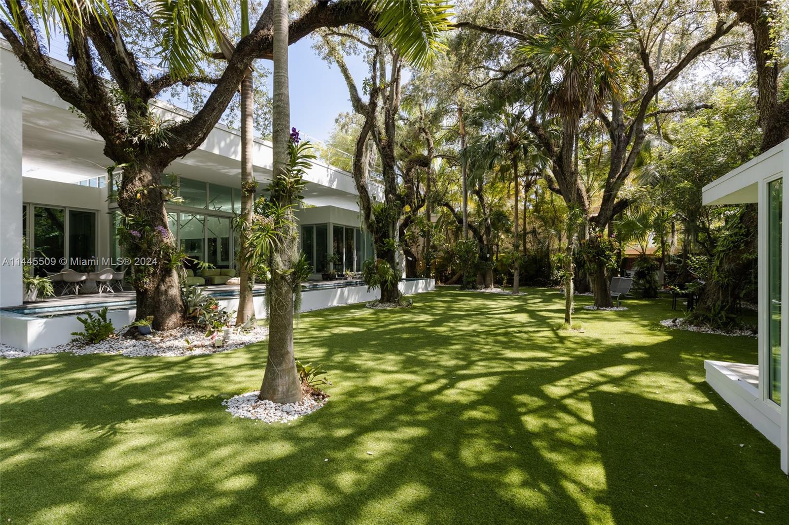 Experience the pinnacle of luxury living in this remarkable single-story home in the prestigious Coconut Grove neighborhood. This 5-bedroom, 5 1/2-bathroom masterpiece, built in 2015, redefines elegance and sophistication, offering an unparalleled lifestyle on a sprawling half-acre lot. Step into a world of opulence where every detail has been carefully crafted to perfection. The open-concept design seamlessly blends modernity with classic charm. Five spacious bedrooms, each with its own en-suite bathrooms. Chef's dream kitchen features top-of-the-line appliances and expansive countertops. The backyard is a sanctuary of tranquility and offers ample space for outdoor activities, gardening, or simply enjoying the Florida sunshine. Dive into pure luxury in your own infinity pool.