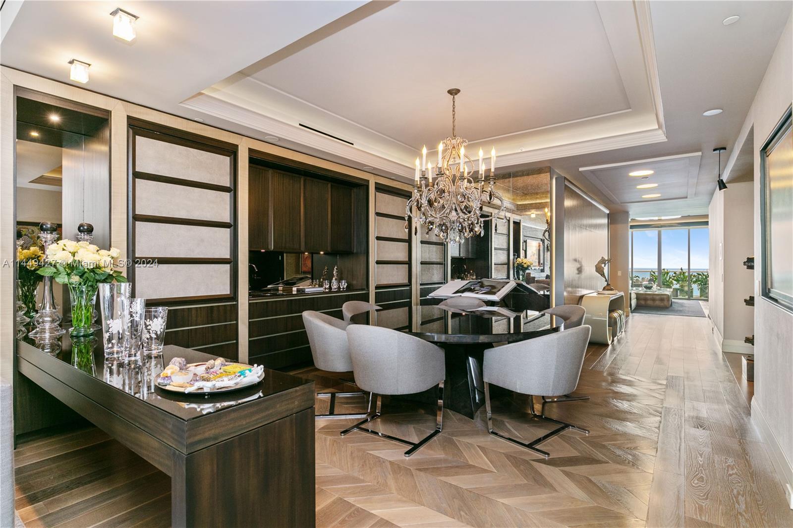 Modern elegance at its finest. This professionally designed residence has spared no expense and is offered turnkey furnished with ultra-luxury appointments, ready for move-in. Featuring wood flooring with herringbone installations, an oceanside living room and cityside family room, formal dining with wet-bar, expansive primary bedroom with seating area, chef's kitchen with gas range, fully-automated smart home technology and many other fine details. The two expansive terraces have been fully appointed and feature Zen-style gardens. Well-suited for large families and for entertaining. St Regis is the epitome of resort style living offering Five-Star, white-glove services and amenities. A+ location directly across from the Bal Harbour Shops.