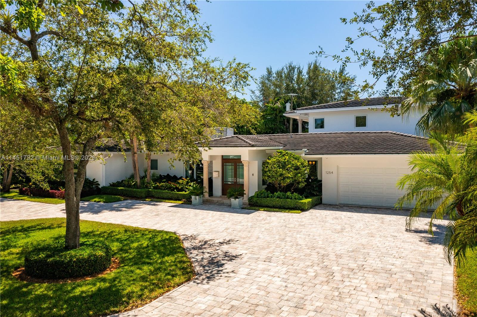 Fall in love with this captivating estate on a beautiful tree-lined street in Coral Gables! Situated on a private 13,200’ lot, this 4 bed/4 bath home radiates elegance, quality and sophistication from the moment you enter the foyer. Remodeled in 2015 with exquisite details, the wood floors, crown moldings, chair railings, and plantation shutters enhance the generous living spaces. The streamlined kitchen with its 5-burner range, island and marble counters adjoin the sun-filled family room. The spacious second floor primary suite and balcony overlook an inviting pool and lush garden. Impact doors & windows throughout as well as landscape lighting & camera systems. There is much to love in this stunning home with its close proximity to all that Coral Gables has to offer. A Very Special Home.