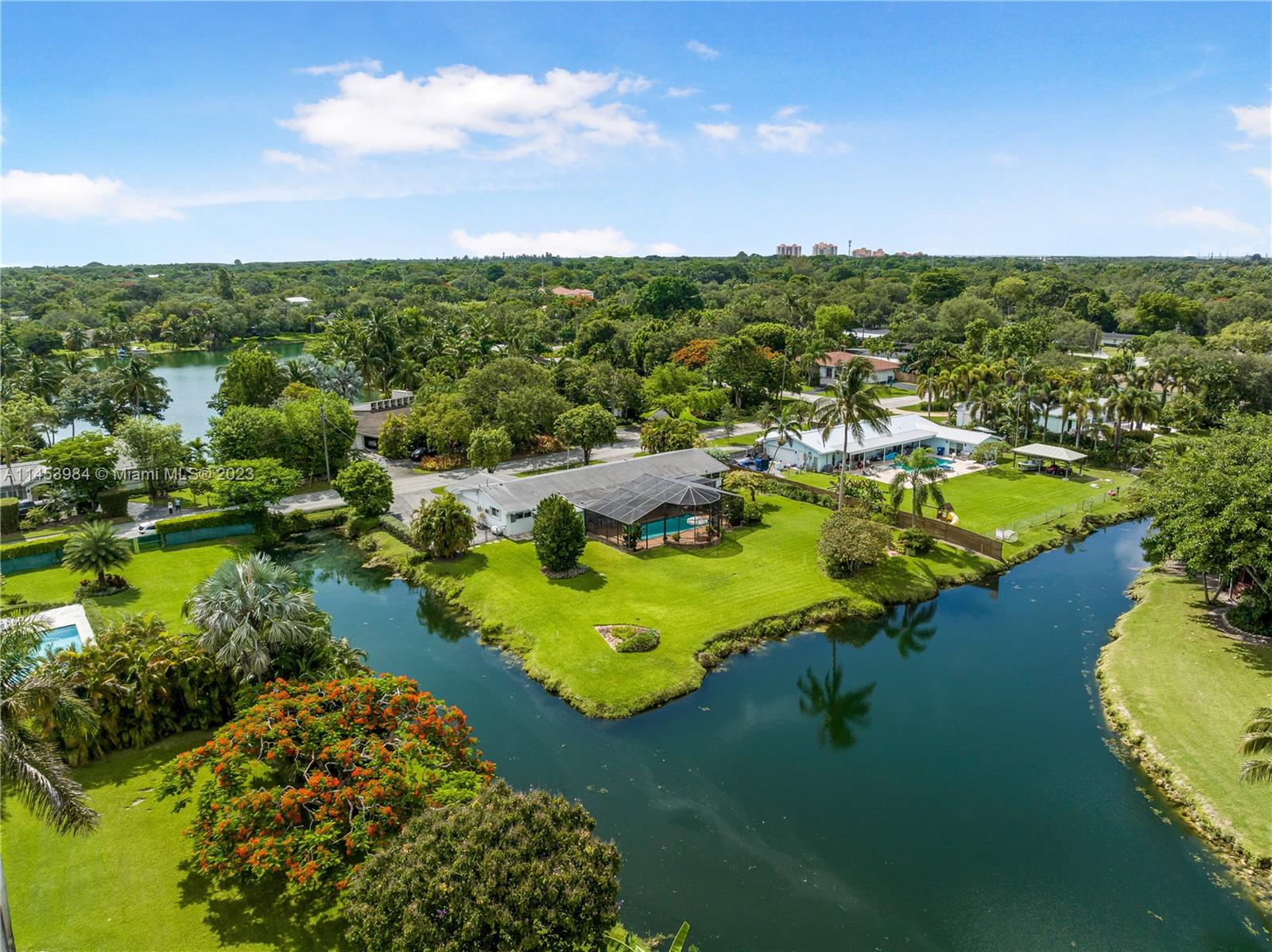 Sellers lovingly maintained this 4/3 home for about 50 years.  It has a peacefull view of a wide canal as it bends creating an open lake-style setting.  Take your small water craft south to several parks and lakes or a bit further north (no bay access).  Property has a new septic and drainfiled located in the front  yard and either impact windows or accordian shutters throughtout.  There is a screened in pool, two car garage and an attached storage shed accessed on three different sides.  Original pipes with PVC in certain​​‌​​​​‌​​‌‌​‌‌‌​​‌‌​‌‌‌​​‌‌​‌‌‌ areas.