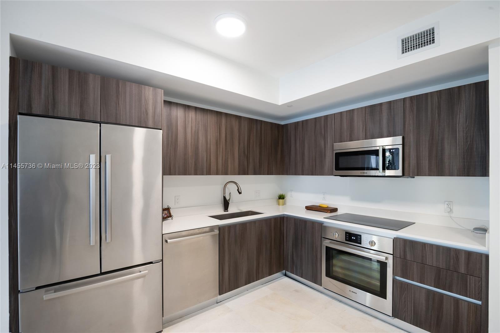 Discover urban luxury at Aria on the Bay, Miami's gem in Edgewater. This 1-bed, 1.5-bath condo offers stunning city and bay views. The open floor plan and floor-to-ceiling windows bathe the living space in natural light. A sleek kitchen with stainless steel appliances and quartz countertops awaits. The master suite features a walk-in closet, bathroom and ample bathroom with with dual sinks. Amenities include in-unit laundry, assigned parking, two pools, fitness center, and lounge areas. Explore Wynwood, the Design District, Brickell, and beaches with ease. Don't miss this chance for sophisticated urban living.