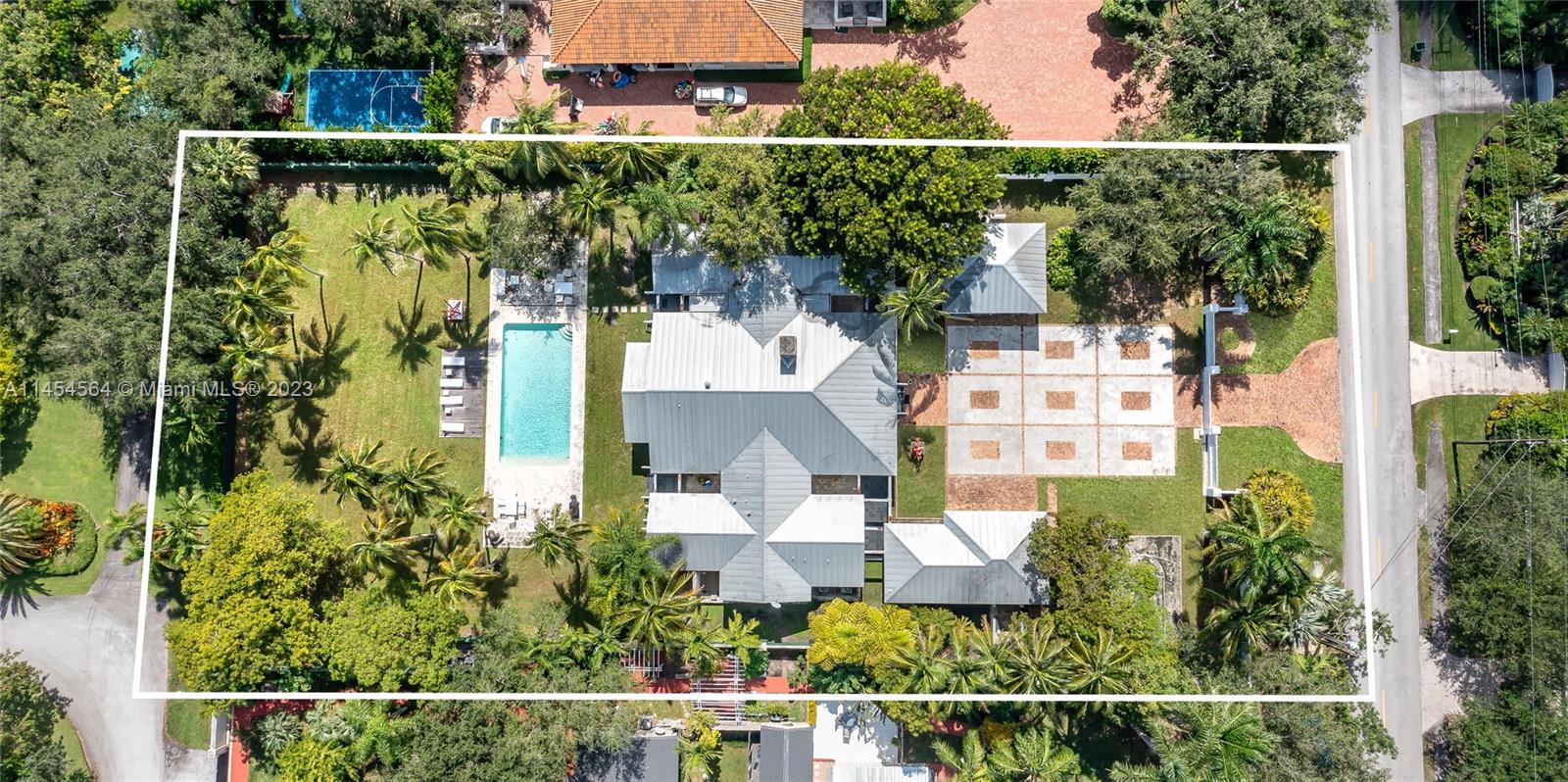 Stunning Key West style estate, situated on a sprawling 1-acre street to street lot in the desirable CORAL GABLES neighborhood. This 7,174 SF Total single-story home, 7 beds, 8.5 baths & 3-car garage, WITH HEIGHT TO FIT LIFT UP TO 6 CARS, which is any car collector's dream. Its prime location near top-rated schools, Gulliver, Carrollton, Ransom, and more. This Multi-Generational home is perfect for In-laws / professional kids returning home, with 3 detached rooms: office w onsite bath, 2 Beds w a sharing bath. The kitchen is complete w top-of-the-line appliances. The primary suite offers a spa-like bath & outside shower. Each of the 4 beds have their own en-suite baths. The outdoor area is an entertainer's paradise, featuring a covered terrace, and a stunning pool w a detached cabana bath.