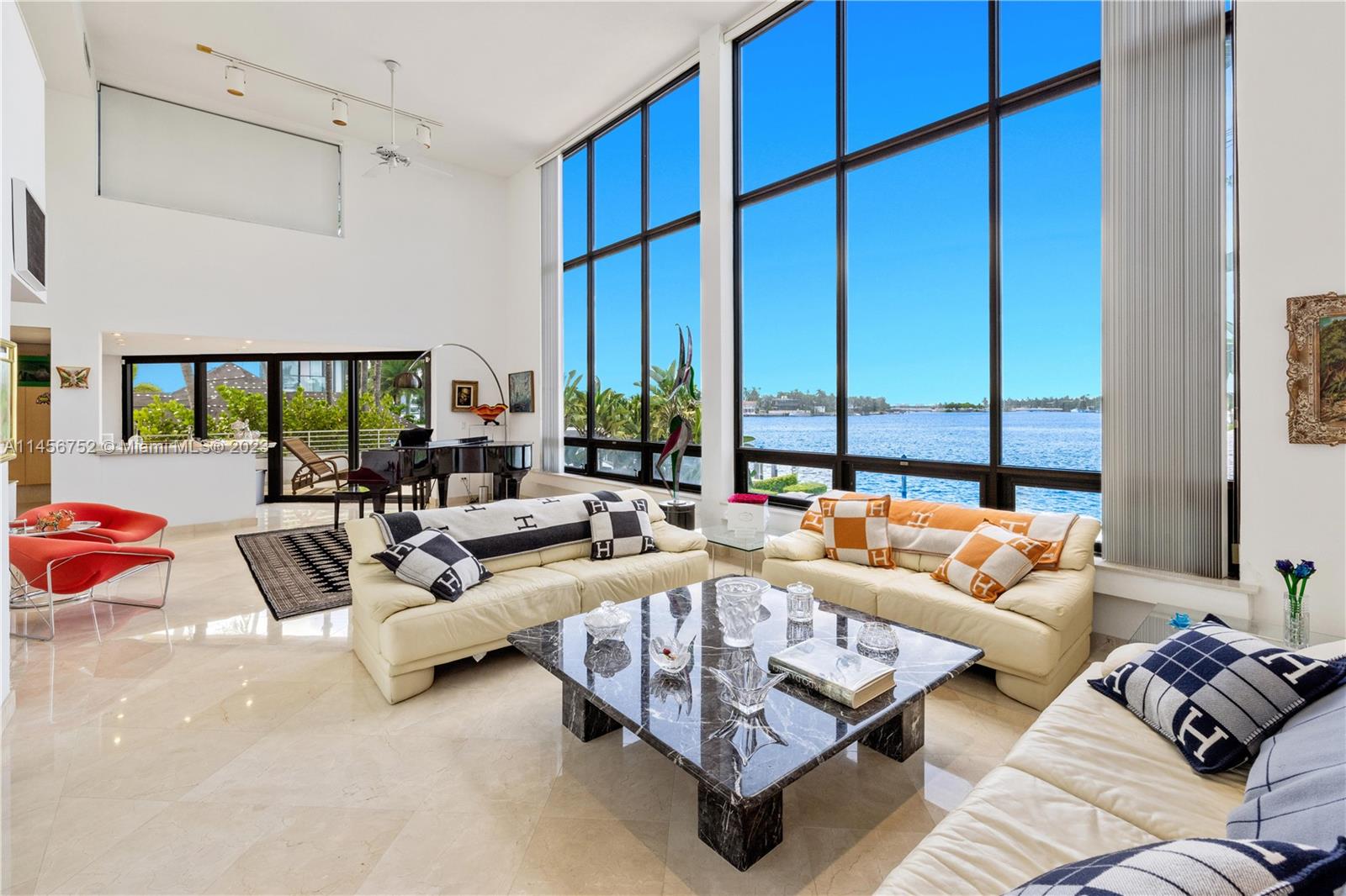 Grand opportunity to live in a spacious waterfront home with a large dock on prestigious Hibiscus Island in Miami Beach. Enter into a grand, double-height living room with 17' high ceilings and a 35' high skylit atrium featuring stunning wide bay views out of  oversized windows. Nested on an expansive 10,500 SF lot, this 5 beds  5/1 baths house highlights a new gourmet kitchen, a media room with an adjoining gym room, a circular driveway with parking for 6 cars, extensive landscaping including 60' Royal Palms. Marble and granite floors throughout, Miele appliances, Poggenpohl cabinets. This entertainer's paradise features a summer kitchen, a large pristine pool, a dock for a 70' yacht  and a direct ocean access. Centrally located on a private island with City of Miami Beach Police guards.