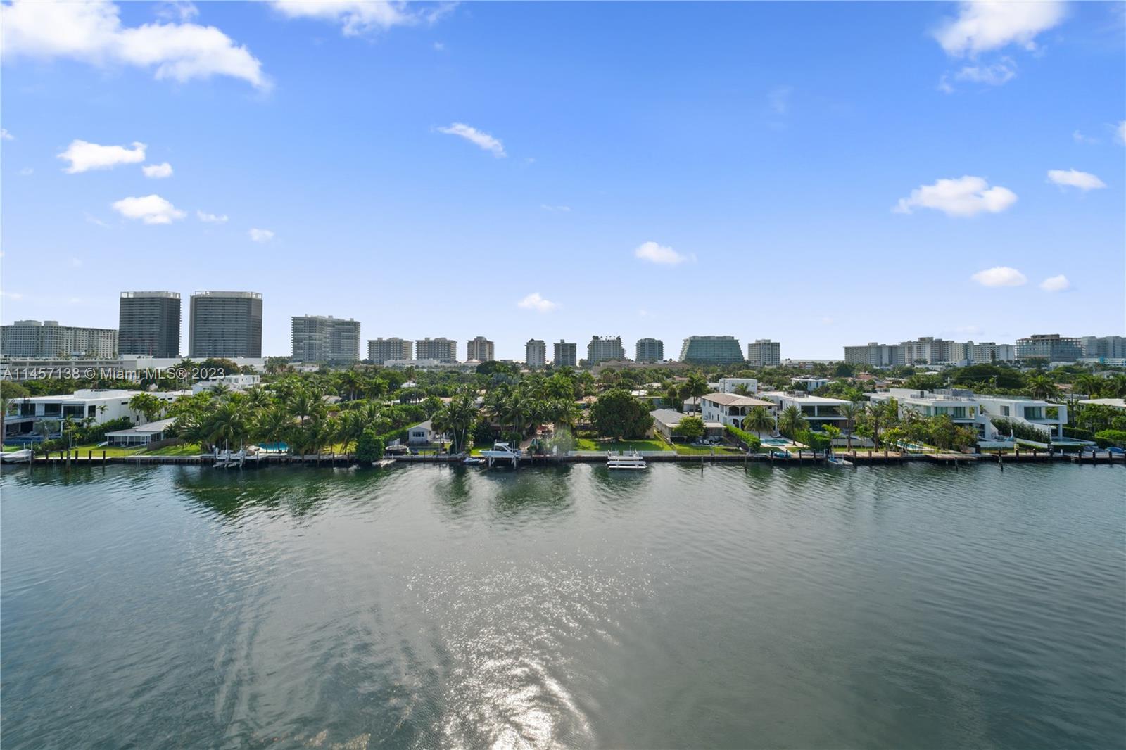 Watch some dolphins while sipping on your coffee from your private balcony with breathtaking water views. Unobstructed direct 180 degree views of the bay, canal and city along with a peek of the Atlantic ocean from this PH corner unit with two oversized in-suite bedrooms w/walk-in closets and 2.5 bathrooms. This 1,640Sq.Ft. unit features a unique blend of modern & traditional styles with immaculate original wood floors throughout, 12' ceilings, European eat-in kitchen, newer A/C unit and plenty of natural light. Sitting right on the Indian Creek canal, this boutique building offers a waterfront pool, only 4 units per floor and assigned parking. Walk to the beach, Bal Harbour shops, A-rated Ruth K. Broad Bay K-8 Center, restaurants, supermarkets and much more.