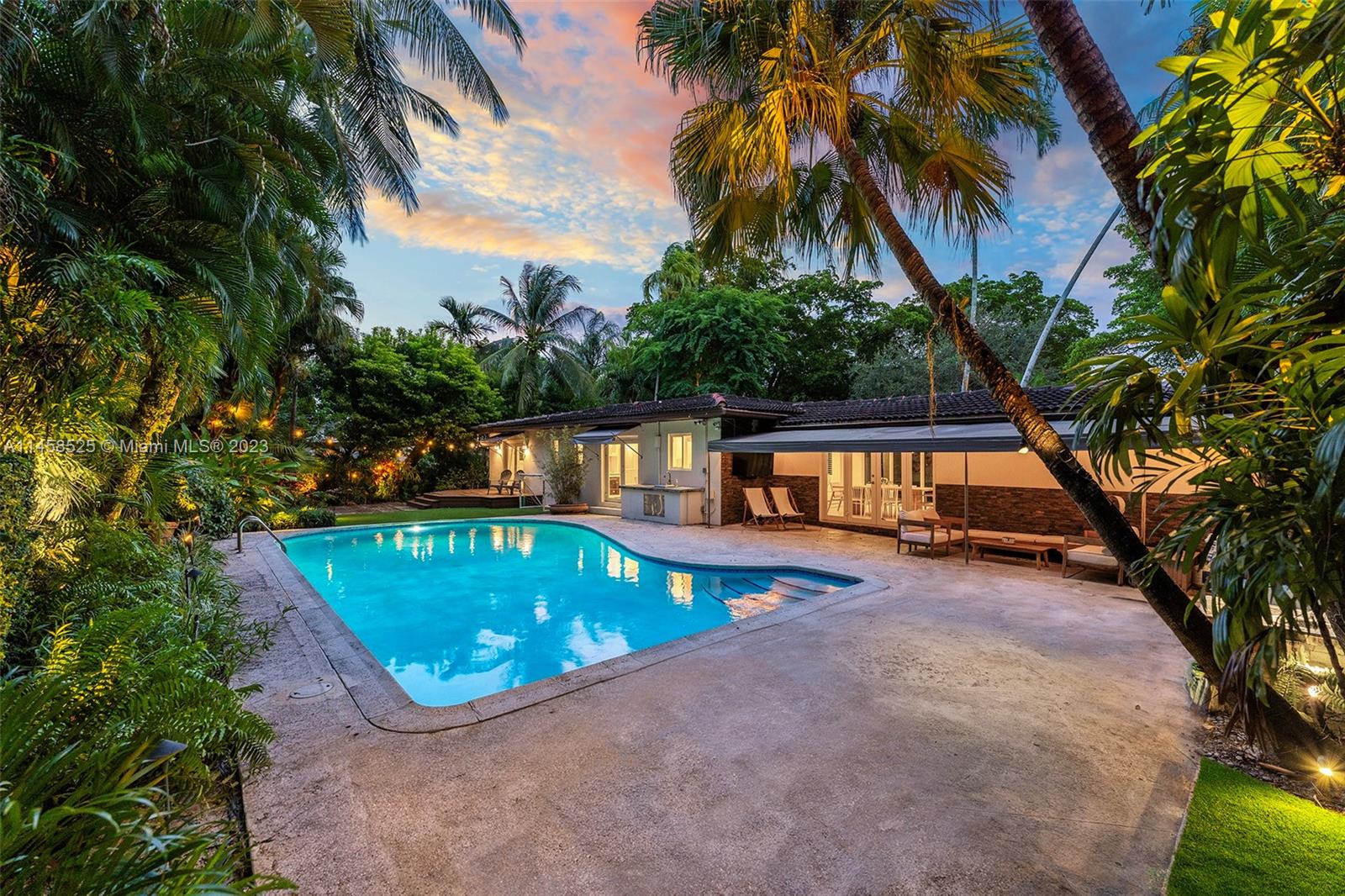 Stunning Residence in the Heart of Coral Gables with Sparkling Pool in Prime Location. Set just one block from the Youth Center and Gables Library, this timeless Gables residence is gracefully positioned on a generous 10,000 sqft lot and complete with impact windows and a brand-new kitchen. Entering from tree-lined Aledo Avenue, the light and bright living room with original hardwood floors leads to expansive dining area, custom kitchen, large office/den and captivating pool views from nearly every angle. The lushly landscaped grounds extend a warm invitation to your own secluded pool sanctuary. Multiple outdoor living spaces include a covered terrace, outdoor kitchen, and private deck off the primary suite offering ample opportunities to entertain and unwind poolside.