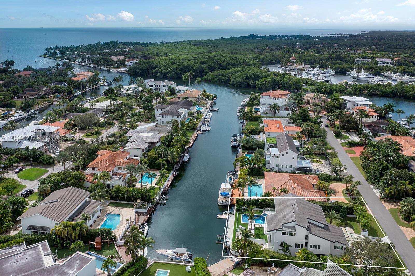 Located within the prestigious and highly sought-after gated community of Sunrise Harbor in Coral Gables, with 100 feet of oceanfront and a private dock providing direct access to Biscayne Bay, this luxurious and modern beachfront residence. The property also has a gym, a playground, and an office. Custom-designed closets and a generous laundry room provide ample storage space. The spacious gourmet kitchen, wine room, and glass bar add to the charm of this exquisite property. This prime location is just minutes from Coconut Grove, South Miami, top-rated schools, and Miami International Airport.