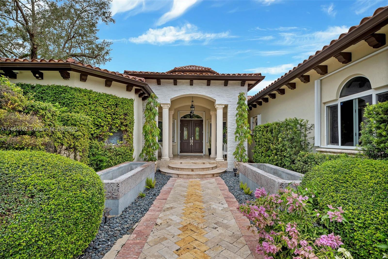 Welcome to your dream home in the heart of Pinecrest, where tropical paradise meets modern luxury living.This magnificent 5-bedroom, 6.5-bath residence has been meticulously renovated to offer the ultimate in comfort and style. The home features a river-style pool that meanders through lush tropical landscaping, with a convenient pool bathroom nearby for your outdoor enjoyment. A built-in BBQ and tiki hut. Inside, discover a gourmet kitchen, spacious living areas with abundant natural light, high cielings, a formal dining room, a home office, and not one but two master bedrooms, each with its own en-suite bathroom and walk-in closet. One of the two car garages was converted into a bedroom with a bath, & can easily be converted back. Statute by the pool does not convey.