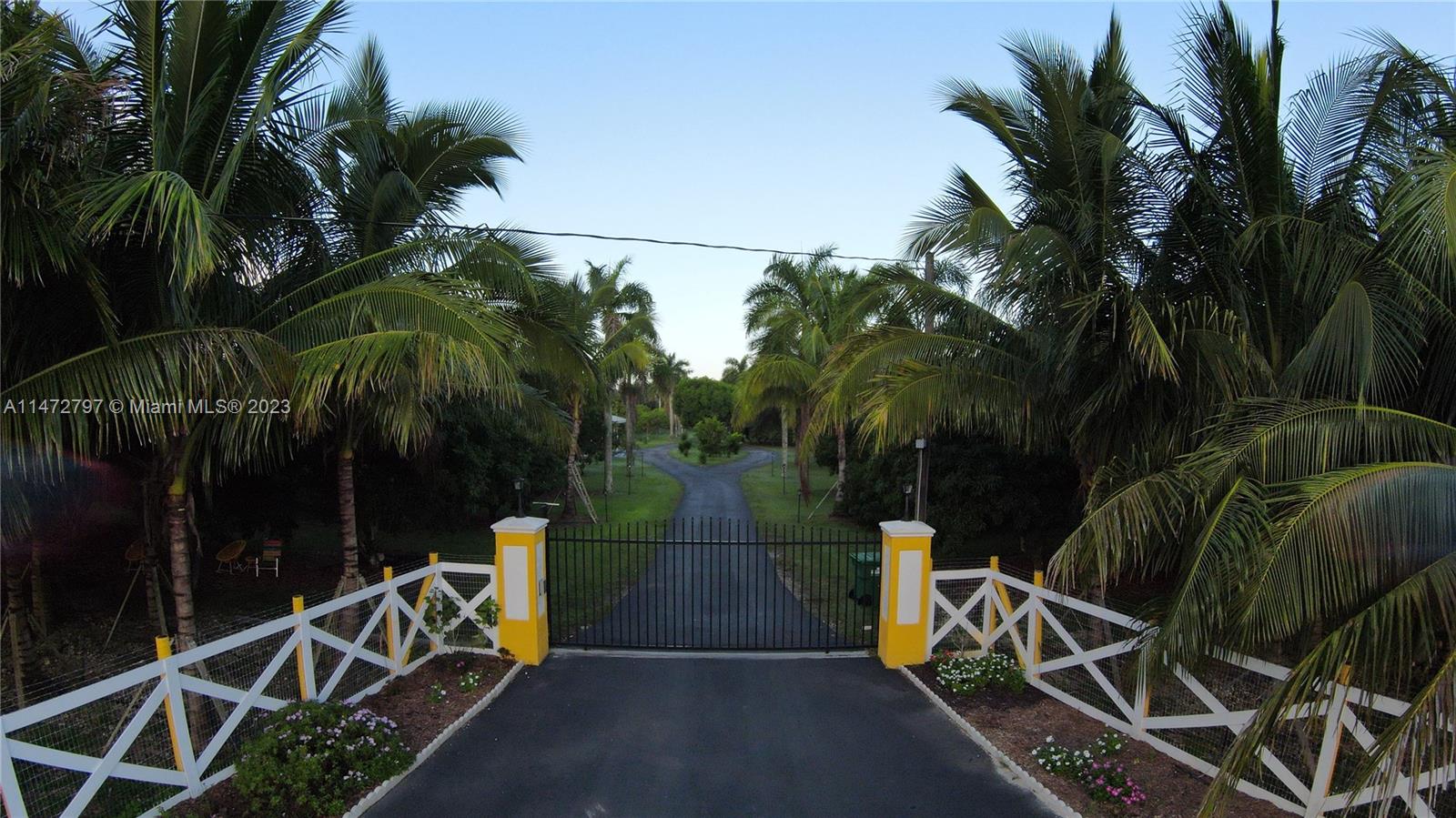 Welcome to a true Redlands oasis. This 4-bedroom 6 bath full concrete block pool home is perfect for entertaining. Come relax on the almost 6 acres filled with fruit trees and a producing lychee grove. There are over 120 lychee trees and 80 coconut trees. 3 separate wells provide irrigation for the grove as well as water for the house. Besides a large custom wall of built in cabinetry The primary bedroom downstairs features his and hers bathrooms and walk in closets. The remaining three bedrooms upstairs are ensuite. The house has been painted and has had 3 new air conditioners installed within the last two years. The house with its over 5000 sq ft of living space will give your family and friends plenty of space to retreat and relax.