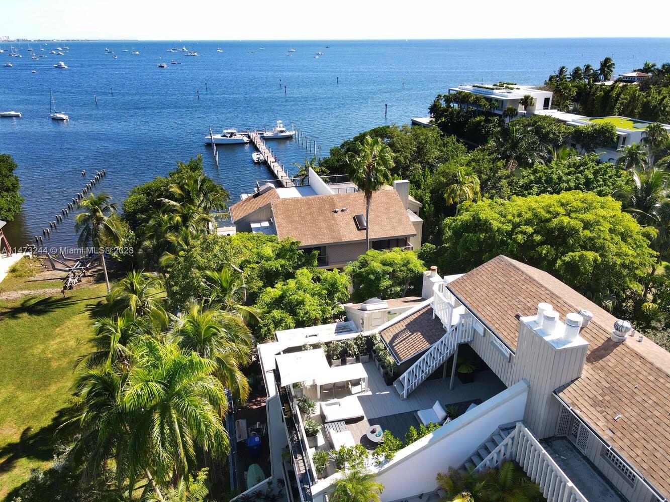 One-of-a kind, spectacular waterfront townhome in Abitare, an ultra-private 24/7 guard-gated community secluded in a natural hardwood hammock on Biscayne Bay. Light-filled living spaces w/25’ ceilings & a modern vibe, overlook the lush tree canopy of the Barnacle State Park. Updates & features include new porcelain tile flooring , all new baths, 1st level private pool + a high-end custom kitchen w/ Eggersman cabinetry & new quartz countertops. 3rd level primary suite features separate sitting area & stunning bath w/ soaking tub & glass enclosed rain shower. Elevator to all 4 levels. Roof top deck offers panoramic bay views. Abitare has a community pool & dock w/slips (35’x25’) available to each residence. Not in a flood zone. Just steps to shopping & dining in the Coconut Grove village.