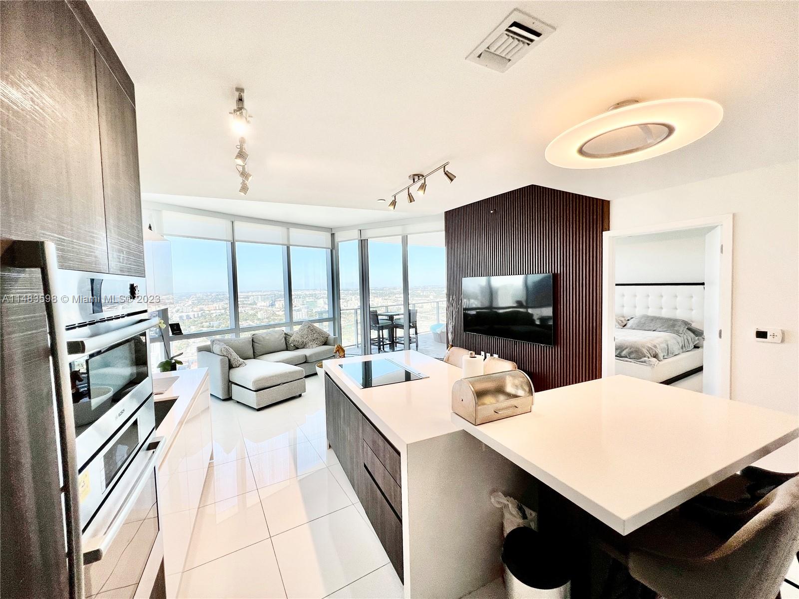 Highest Available 45th floor 1 Bedroom + Den, & 2 full bathrooms. Best line with breathtaking views. This unit offers 10-ft ceilings, floor-to-ceiling impact windows w/remote shades, custom lighting, custom closets, eat-in kitchen with Sub-Zero/Bosh appliances, master bath with duel-sink vanity, soaking tub & glass-enclosed shower, laundry room a specious terrace with bay views. Best line in the building with unobstructed west views with the most amenities- Paramount Miami World Center. Experience luxury urban living with breathtaking views with amenities: 24-hour valet service, spa, yoga studio, fitness center, observatory, Sky Deck, 7th-floor pool-3 pools & cabanas, rooftop pool, boxing ring , golf simulator, theater, jam room & much more. Live in the heart of Miami.