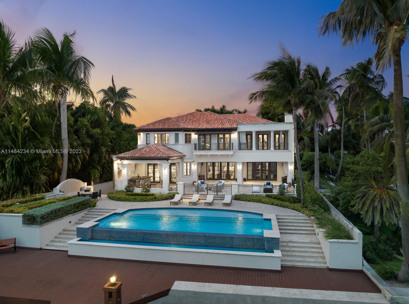 A fairytale story! This timeless Mediterranean Waterfront Villa in the heart of Coconut Grove boasts soaring ceilings, and light-filled open living spaces with custom millwork, all overlooking the most mesmerizing unobstructed and elevated views of Biscayne Bay. The ground level has a seamless blend of indoor and outdoor spaces, a chef's kitchen, the most idyllic waterfront terrace with a covered BBQ area, an infinity pool, and a private dock. The primary stuns with an impressive attached sitting room/office, a private terrace, and captivating bay views. This villa comes with 4 beds upstairs, a study/library, a detached two-bed guest house, a three-car garage, and a movie theater. Located in a double corner lot, this fully walled gated home on a patrolled street is a truly private oasis.