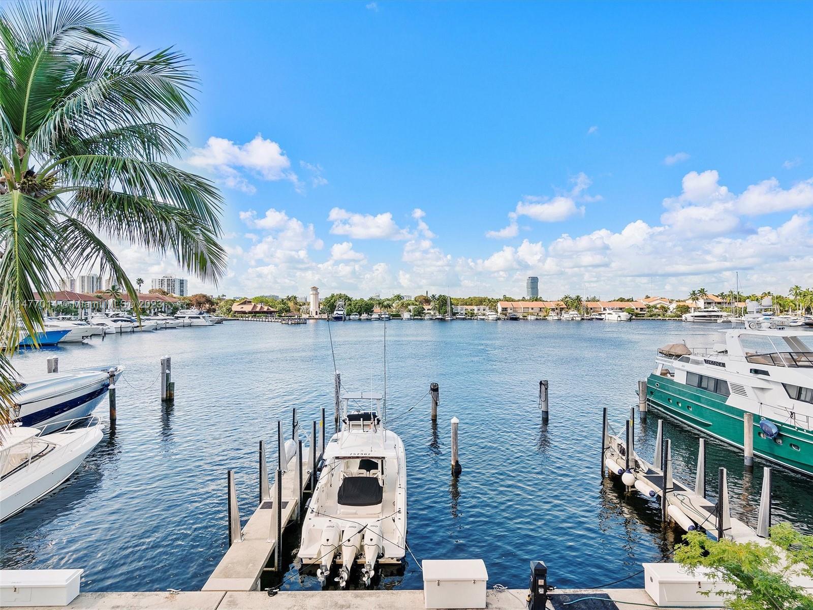 Spectacular 4 bedroom Townhome with 3100 SF of interior living space is located directly on the Waterways Marina. The views are incredible from almost every room!!  This 3 story TH is fully equipped with an interior elevator.  Enjoy all that South Florida has to offer in this gated Prestigious community. The floor plan offers so many options including adding additional bedrooms on the first floor.  The ground floor offers a family room, 2nd office, bar, laundry room and bathroom.  On the second floor is the open kitchen and living room and formal dining area. On the third floor there is the master bedroom, guest bedroom and extra room, can be a bedroom or an extra closet.  This residence has been freshly painted.  This is the largest residence available in the community and will go quickly