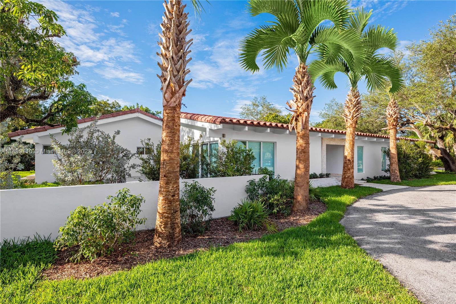 Rare opportunity to live in a turnkey centrally located home in the heart of Coral Gables. This fully remodeled 5 bedroom, 4.5 bath home exudes contemporary living charm in a 3,942 sq ft home on a 37,810 sq ft lot. Features include classic white exposed beams, volume ceilings, wraparound impact doors and windows, and an abundance of natural light. The spacious kitchen comes with a breakfast nook, smart appliances, laundry room, custom built-ins, and porcelain tile flooring. A two-car carport and two separate driveways provide ample parking. The lushly landscaped outdoor space is the perfect place to relax, with grand mature oak trees lining the property and a private courtyard offering a Zen-like retreat experience.