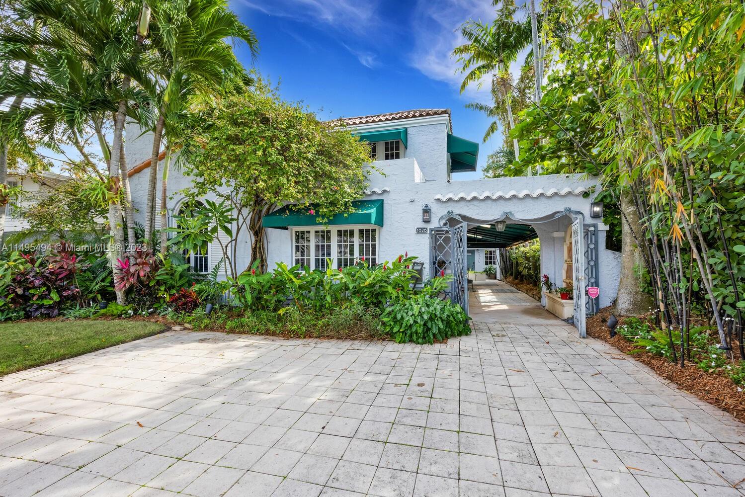 Captivating home on quiet street in prestigious North Coconut Grove. Walk or bike to Biscayne Bay, Kennedy Park and Grove village center. Generous, light-filled living spaces feature classic architectural details, high ceilings, original fireplace, Italian travertine & oak flooring throughout. Updates include eat-in kitchen w/wood cabinetry, quartz countertops & Viking & JennAir appliances + PVC plumbing + full storm protection. Expansive family room features wood beamed ceilings & French doors overlooking the lushly landscaped, private Chicago Brick courtyard with room for pool. Main house 3BR/2BA + detached 1BR/1.5 BA guest house w/living room & full kitchen. Neighborhood security patrol. Parking for 5 cars & wired with EV charger. Minutes to downtown MIA, Key Biscayne & Beaches.