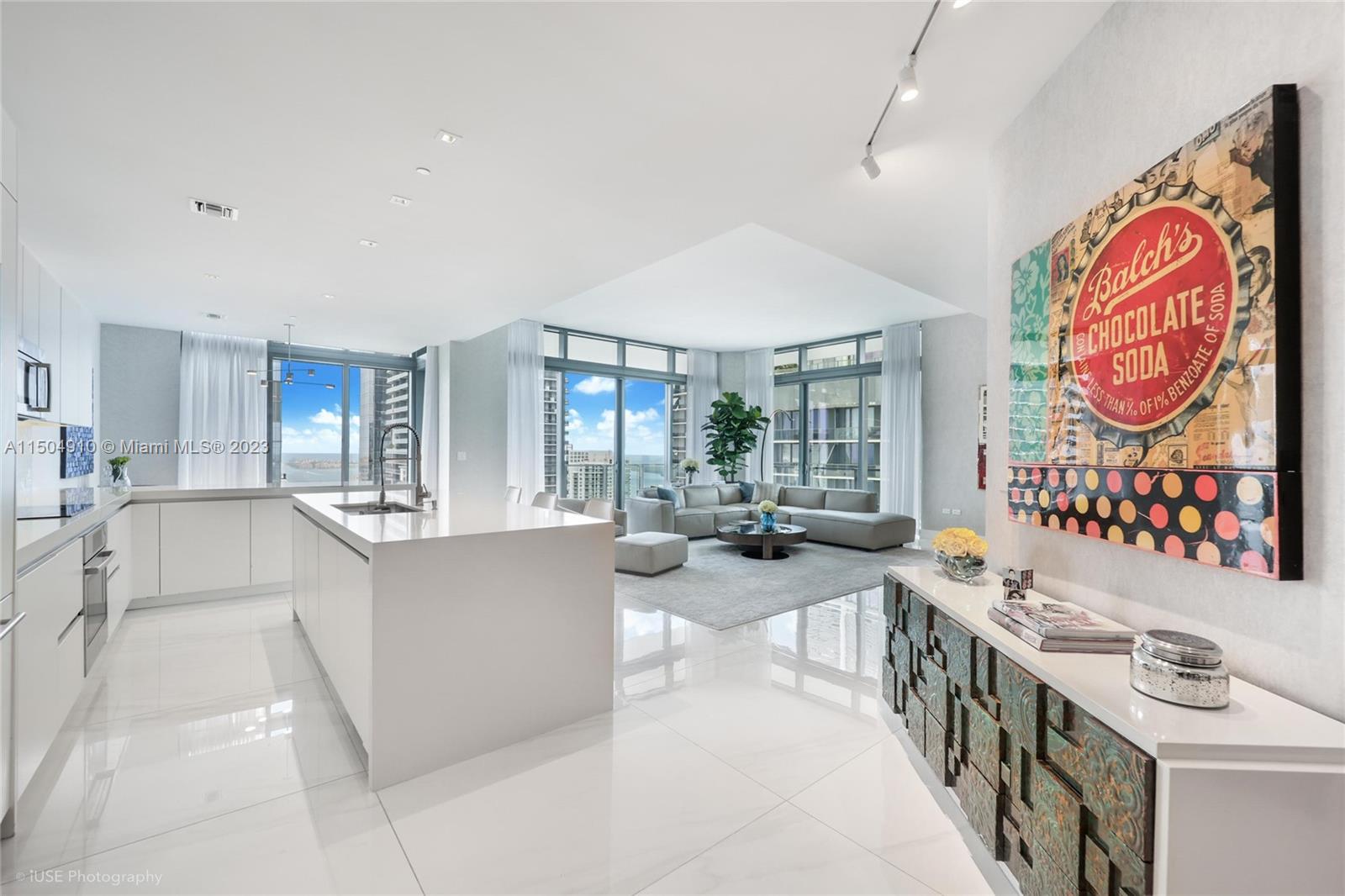 Stunning corner 4BR/4.5BA lower penthouse unit offering breathtaking panoramic water and skyline views from sunrise to sunset in the elegant Rise building adjacent to Brickell City Center Mall. 12' ceilings with 48"x48' white Italian porcelain floors throughout the unit recently installed in 2022. Custom Italian finishes and upgrades throughout the apartment. Large wraparound 9ft deep balconies offering 360-degree views. Walk-in closets in every bedroom featuring Italian cabinetry. Electrical window treatments and white custom shades. Quartz counter kitchen tops with waterfall island and floating cabinetry in bathrooms. Large laundry room w/ additional storage and maid's room w/bathroom. The unit includes 2 parking spaces and free valet service for visitors.