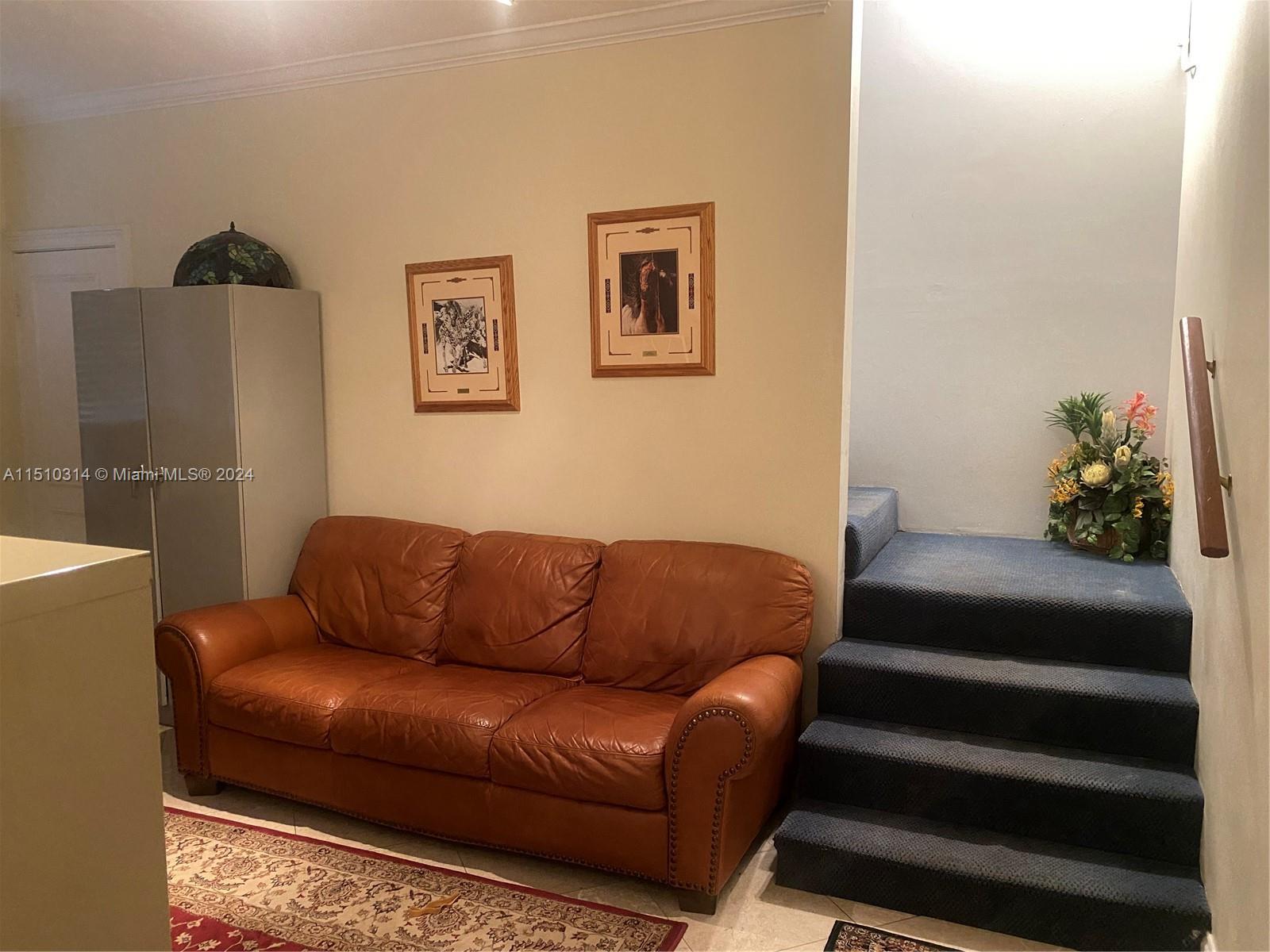 Foyer of staircase ideal for additional office. Janitorial storage under stairs
