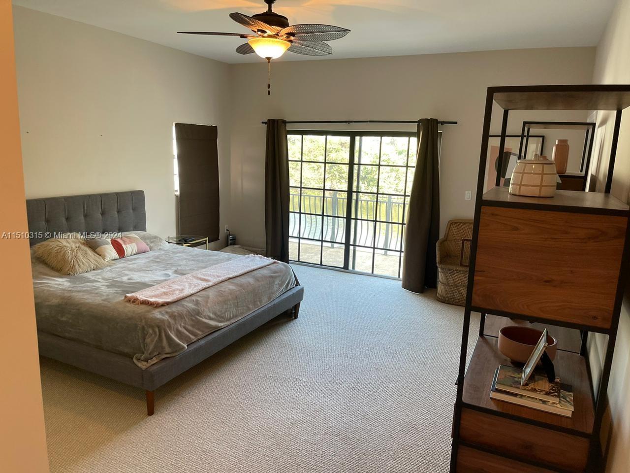 Main bedroom with balcony overlooking the patio and the canal.