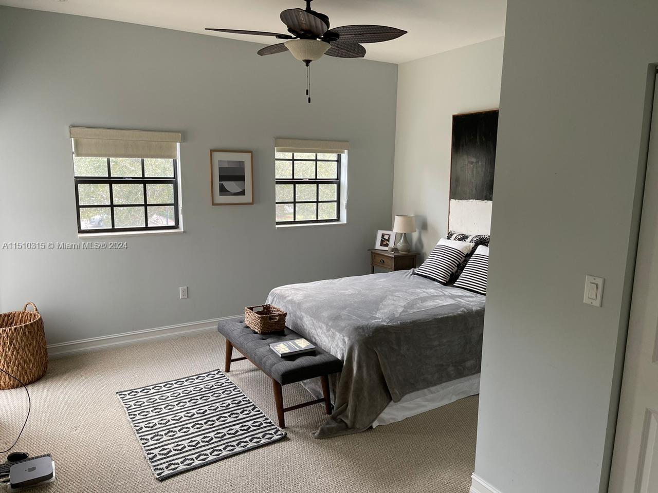 Bedroom #2 with door to its balcony to the left. It features a walk-in closet and ensuite bathroom.