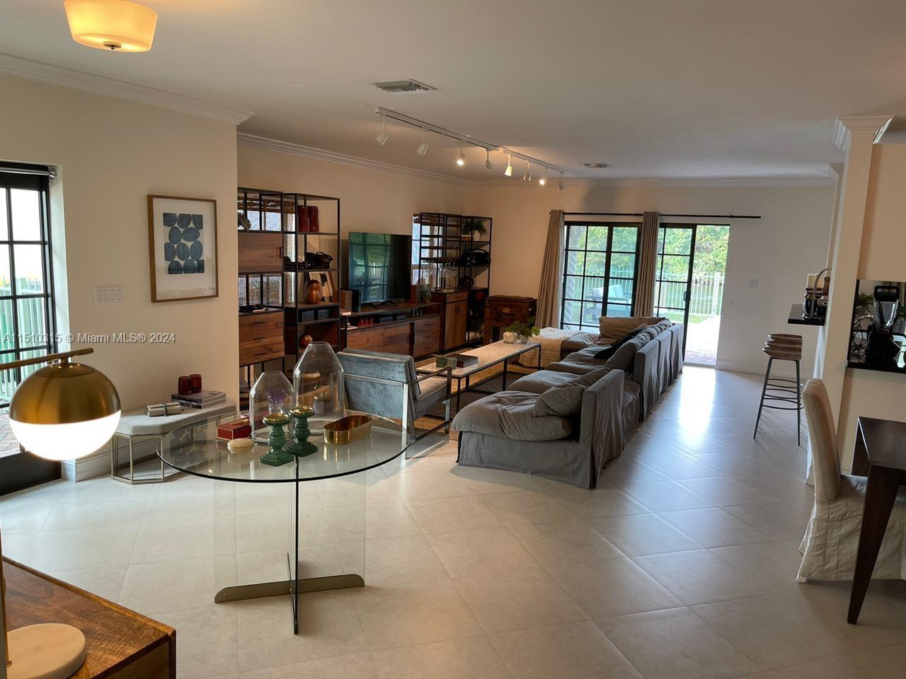Overview of the living room area and the patio access in the background.