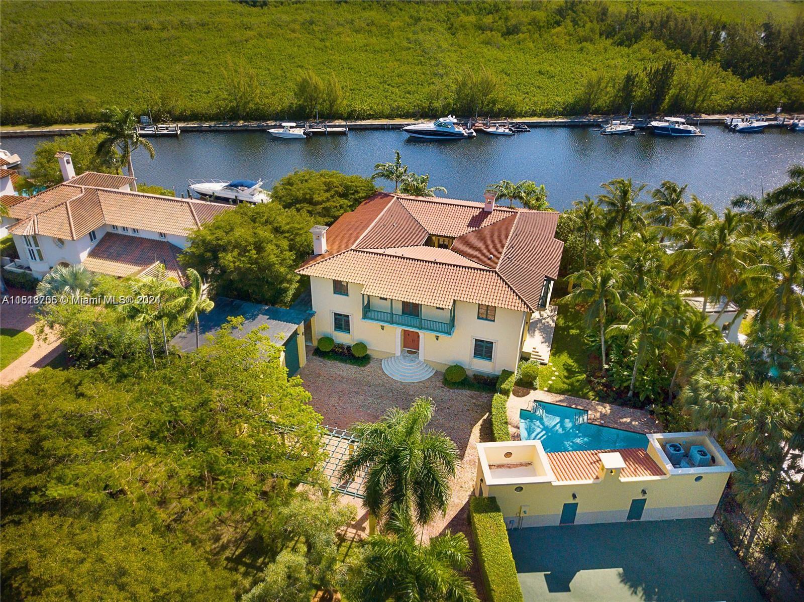 Waterfront Coral Gables gated estate with dock, serene unobstructed waterfront views, and professional tennis court on nearly one acre! This Portuondo Perotti designed home, in the quiet guard gated neighborhood of Hammock Oaks, is situated on a 40,000 SF lot with a ±7,000 SF home, 2 Spectacular Tree Houses! This beautiful home has 6 Bed/5.5 Bath (+2 Bonus Rms, Office, Gym Totaling 8 Rms), Living Room and master bedroom with fireplaces, beautiful Courtyard and a separate Barn Style Garage bringing exquisite style to this home!  Unobstructed Serene Waterfront Views, includes 12ft Ceilings, Italian Marble, Hardwood Floors , Pool, Cabana, only one bridge to Open Bay, 36’ Dock on Almost 100 Ft Linear Waterfront …. It’s a very Quick Seven Minute Drive to Open Bay!! Must See! Won’t Last!