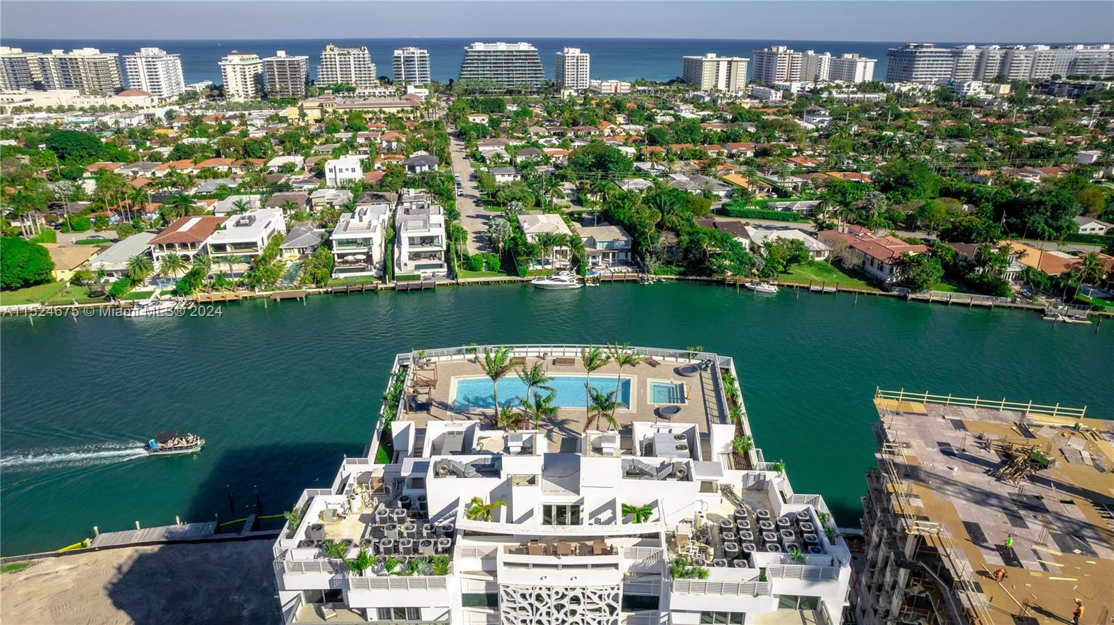 RARE OPPORTUNITY! Luxury fully furnished unit with partial water view in the sophisticated Bay Harbor Islands. This TURN-KEY RESIDENCE is fully equipped, featuring modern high-end furniture, premium wood tile, and numerous upgrades. Enjoy a ROOFTOP POOL WITH STUNNING VIEWS. The 2-bed + large den (converted to A 3rd bed) offers 1,305 sqft of living area and nearly 400 sqft of balconies. Situated in ONE OF THE MOST SOUGHT-AFTER AREAS in Greater Miami, very close to Indian Creek, A-rated schools, and just minutes from the beach, Bal Harbour Shops, and trendy restaurants. Includes 2 ASSIGNED PARKING SPACES (a rarity on the island) and storage. New ultra-luxury building (La Baia) under construction on south lot, adding GREAT VALUE to the area. Don't miss out!