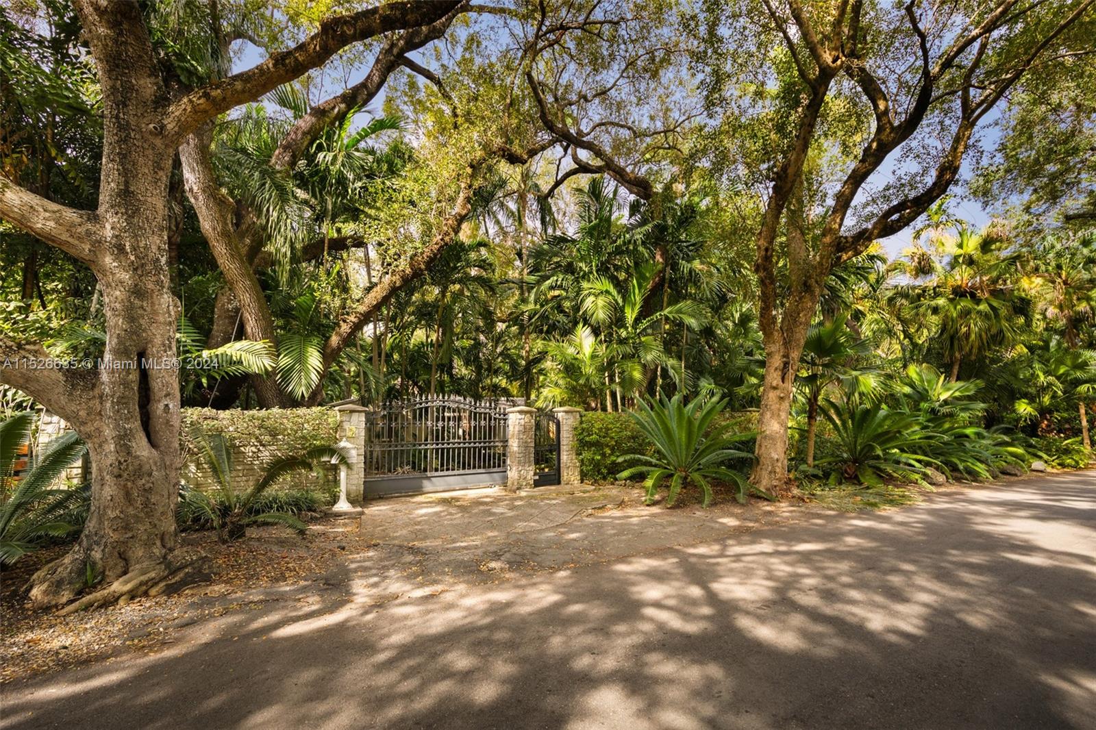 Quintessential “Old Miami” style home on a coveted, oak canopied North Grove street, in a neighborhood of large estate homes. Walk to bayfront parks and marinas and close to the Grove village center’s galleries, boutiques & cafes. Walled & gated, exceptionally private grounds (20,000 SF) w/winding walkways through the lush tropical gardens. The main house is 2005 SFLA and features 3BR/2BA, vaulted beamed ceilings, original fireplace, wood flooring and French doors that open to 25 meter lap pool & expansive wood deck. Charming guest house (500 SF) offers open living/bedroom space & marble bath. Listed at land value. Not in a flood zone (one of the highest elevations in South Florida. Ideally located just minutes from downtown, MIA, Coral Gables, Key Biscayne & the Beaches.