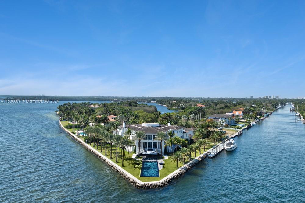 41 Arvida Parkway with its 8 bedrooms and 9 ½ baths, epitomizes luxury and bayfront living, on a unique 54,000+, v-shaped point lot with direct access to Biscayne Bay and the Atlantic Ocean. This architectural marvel, designed by Ramon Pacheco, offers 574’ of prime views, a private 140’ boat dock for yachting enthusiasts that can accommodate a 170+ foot mega yacht, 5 car garage, floor-to-ceiling windows, a fabulous Mick De Giulio kitchen, a stunning bayside, one-of-a-kind pool designed by Estudio Arque, landscaped gardens and multiple outdoor entertainment areas. This exclusive retreat, where open waters meet sophisticated living, is a haven for those seeking coastal elegance, security, privacy and access to nearby airports and the world!