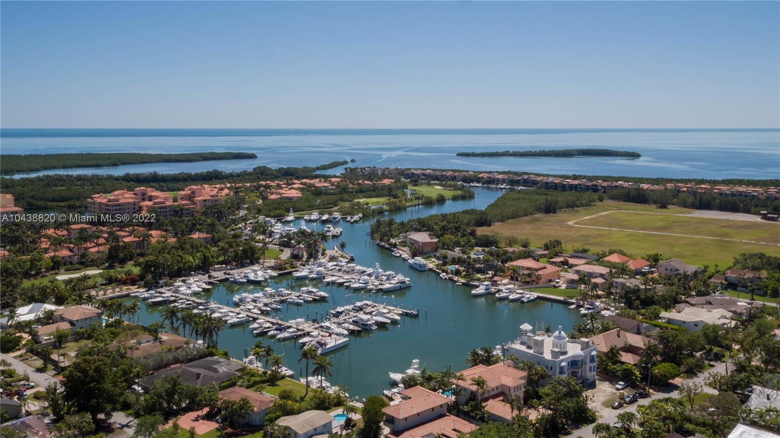 Just minutes to the bay from a private dock - rarely available gorgeous waterfront home with stunning Wide Views of the Deering Bay Marina and deep water lagoon - 100' sea wall accommodates five 50' boats - no bridges to bay or ocean. Located in prestigious Coral Gables gated community of Kings Bay Estates. Features striking interior spaces, several balconies, formal dining, gourmet kitchen with cooking island, soaring ceilings, over-sized rooms, sweeping staircase, first level is a 3300 SF garage for 8 plus exotic or otherwise personal vehicles, elevator from garage to upper level interiors, and a 24/7 recorded nine camera security system . Incredible for ardent car and boat enthusiast.
