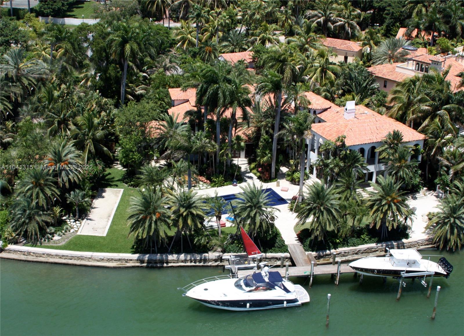 Mediterranean Revival home fully renovated in 2009.  The gut renovation included a large addition hosting the new master bedroom, kitchen and family wing.  This gem sits nestled inside lavish and exotic specimens on a 35,348 sq ft lot with prime south exposure with 220’ of waterfront capable of docking up to a 205’ boat.  Enjoy amenities such as home theater, gym, steam rooms, bocce court, center courtyard & wine cellar in Police gated Palm Island.  The home is fitted with all of the latest technologies such as lighting control systems, smart home technology,  solar panels, heated pool & spa, beach area and a separate guest house.