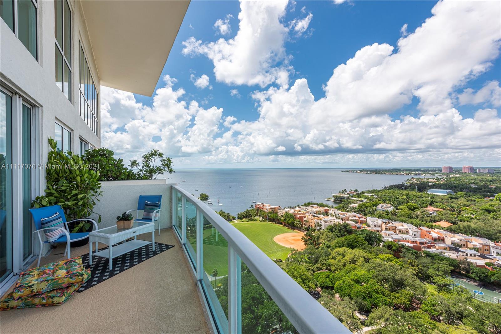Spectacular 2-level, corner penthouse with sweeping views of the Grove village & Biscayne Bay. 25’ ceilings w/ walls of glass opening to large balcony & tropical lanai for outdoor dining. 2BR/2.5 BA + den/office. Being sold fully furnished with stunning designer pieces throughout. Full-service Condo/Hotel offers 24 hr. concierge, state-of-the-art fitness center, 8th floor pool, sun deck & restaurant with water views. Located in the center of the village of Coconut Grove. Walk to galleries, boutiques, cafes and bayfront parks & marinas. Unit is currently rented through May 2022. Two assigned parking spaces & valet parking available. No association approval required.