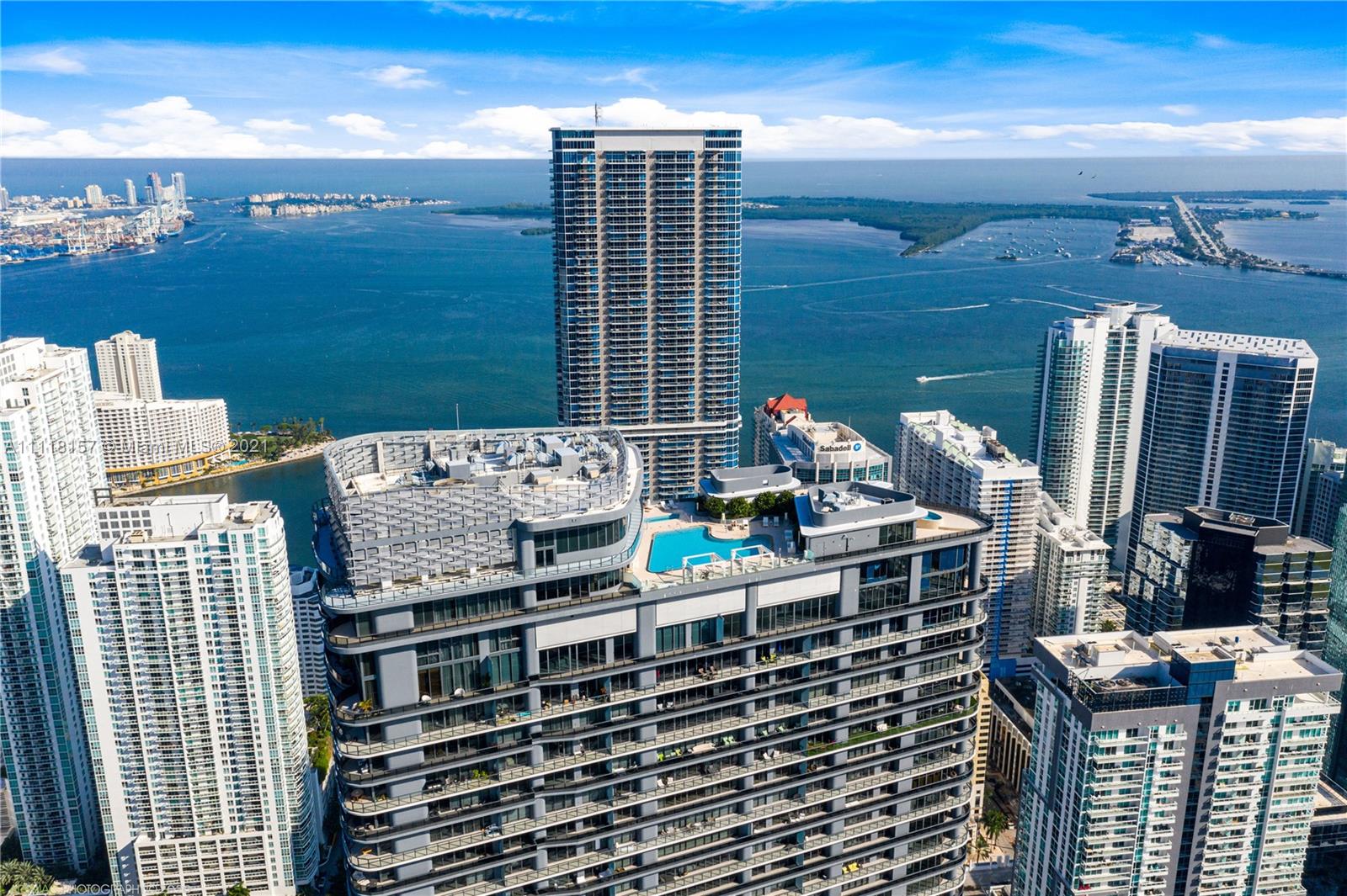 Brickell Flatiron Penthouse. Unobstructed panoramic views with SE Exposure [Best line] Corner unit with wrap around balconies throughout. 3 Beds- 3.5 Baths with 1,955 SQFT of living area, 10 ft. ceilings, floor to ceiling impact windows and sliding doors, Italian Snaidero Kitchens and Bathrooms, built-out closets, Miele appliances, and other luxury finishes. Full-service building with concierge service and resort style amenities includes the 64th Floor Sky Club, a spa, gym, theater, and lap pool, club room, lounge room, movie theater & Billiards. Two assigned parking space and valet service. Fantastic location in the heart of Brickell. Vacant turn-key unit easy to show.