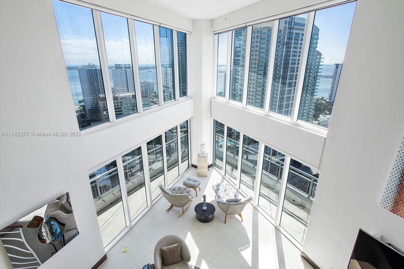 This stunning and visually dramatic two story award-winning designer residence at Infinity at Brickell is a one of a kind fully-furnished corner unit. Floating 26 floors up on the south east corner with expansive views of the bay, ocean and the city. This unit will wow you from the very entrance with the double height ceilings and floor to ceiling glass windows that make you feel like you are in the clouds. This 2,734 sq ft 3 bedroom, 3.5 bathroom features custom floating staircase, Apure Architectural Lightning, Boffi vanity, Toto toilets, custom closet cabinetry, and Italian furniture. Building amenities include: pool, jacuzzi, sauna, steam room, bike storage, 24hr security, concierge, valet parking, and a café/market in the lobby. Enjoy walking to everything Brickell has to offer.