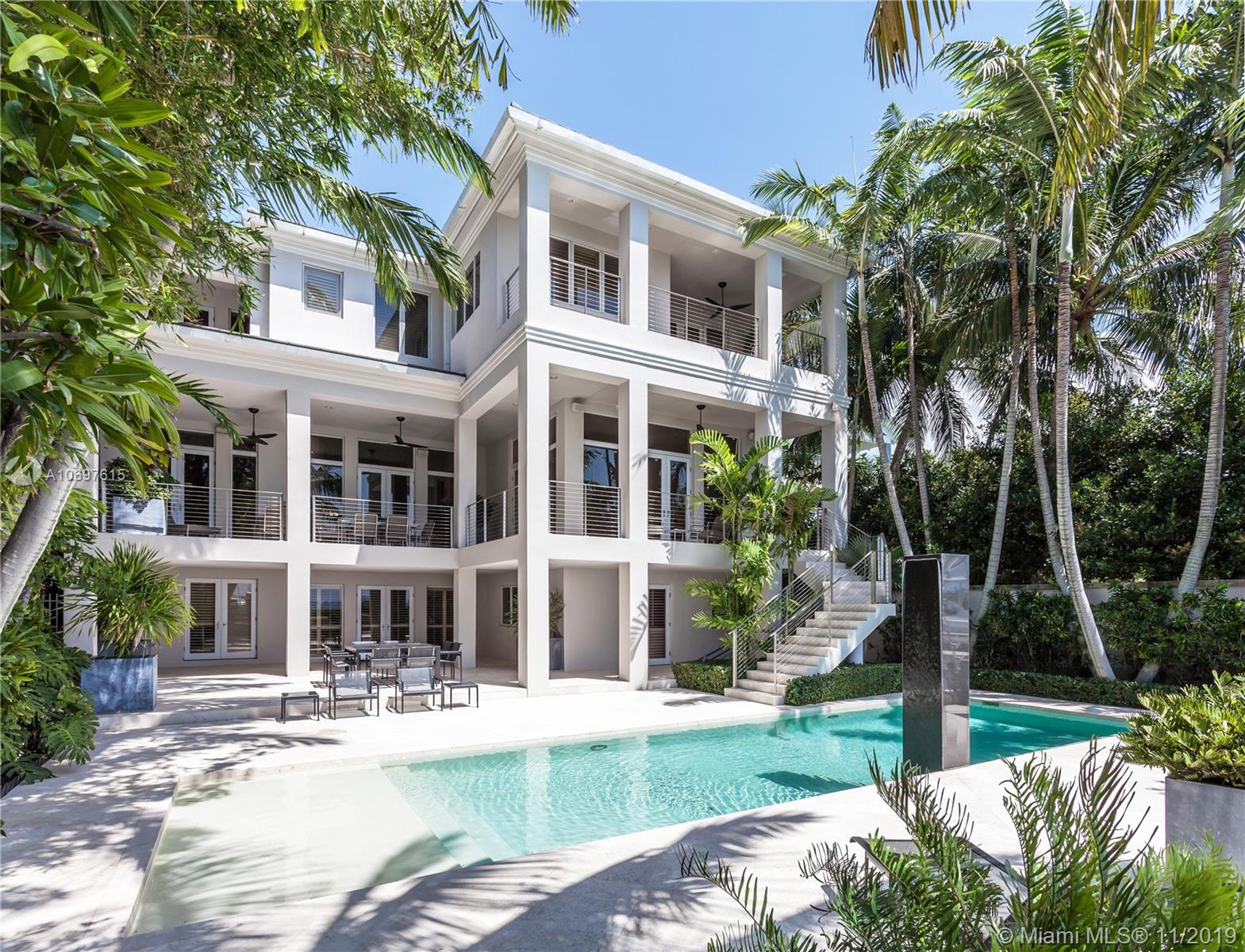 Sophisticated living in Coconut Grove’s blissfully tranquil, waterfront gated community of Hughes Cove. Breathtaking inside-outside living spaces with sleek design and luxurious finishes, which are enhanced by heavenly views of the bay and its sparkling water. The 3-story residence’s main floor comes with an office, living room with wet bar, custom marble countertops, kitchen with large island and state-of-the-art appliances. Custom staircase leads to the upper floor, where sliding glass doors open to the spacious terrace off the master suite. Waterfront patio offers an array of dining and lounging options, a delightful swimming pool with waterfall and sun deck. Residence also features an elevator that goes to all floors, and spacious 7-car garage for car enthusiasts.