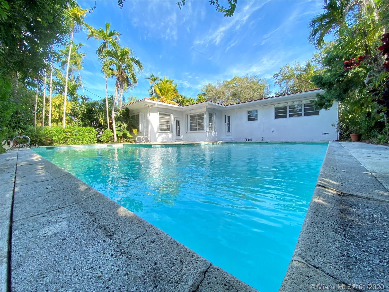 Spacious & bright residence in highly sought after community of Bay Heights. Double doors welcome you to the extra large, open floorplan concept living space, perfect for entertaining. Oversized Living/dining room surrounded by windows overlooking the patio & very large pool.  The garage has been enclosed, creating a private 4th bedroom suite, perfect for guest room, office, playroom, library or den. With 9000sf of land, this residence offers incredible potential for renovation/expansion. Other features include eat-in-kitchen, original marble floors, utility/laundry room, circular driveway & newer roof. Bay Heights is extremely desirable for being on high elevation, offering 24hour police patrol & close proximity to top rated schools, Brickell, Downtown, Key Biscayne & Miami Beach.