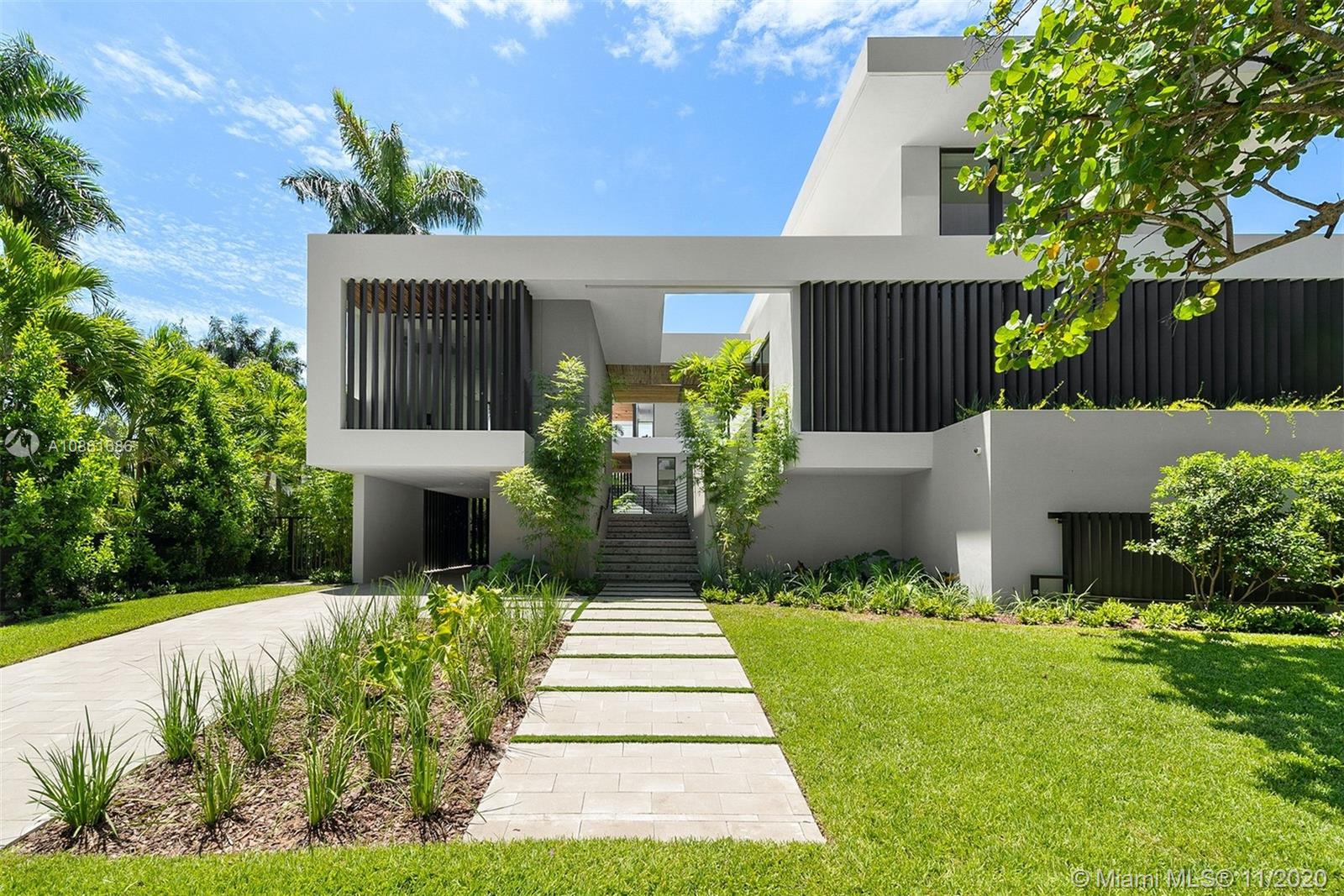 Brand new home on sought-after Entrada Estates gated community in Coconut Grove. Designed by Praxis' Jose Sanchez and built by ICH Builders, this modern Smart home is warm & elegant with clean lines and superb finishes. Boasting 7369 SF under air, the home features floor to ceiling windows that drape it in natural light, thoughtful floor plan, 250+ glass wine room, elevator, additional large room ideal as a media room/man cave/office, second family room on the top floor, 5 carports & plenty of storage. Gourmet kitchen w/ top of the line appliances, ample pantry & gorgeous countertops and Mia Cucina cabinets. Expansive grounds perfect for entertaining w/ summer kitchen & covered spaces for large gatherings. The multi-depth heated double pool allows for swimming & leisure activities.