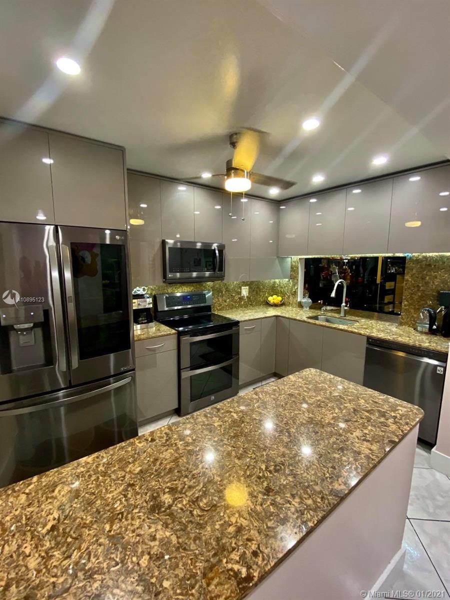 Welcome to a Pompano Beach hidden gem! What a great gated waterfront oasis to enjoy! PRIVATE DOCK AND FULLY RENOVATED. One fix bridge and 5 minutes to the ocean access by boat. Less than 5 minutes drive and 15 min walk to the beach.  This is by far one of the best units in the complex that's finally on the market for the first time in almost 20 years. Just renovated with spectacular european custom made in Spain kitchen with durable quarts counter tops and top of the line smart LG appliance package. Brand new bathrooms both with walk in showers, brand new A/C unit, brand new water heater, and a well maintained oversized private dock for an up to 28' boat. Lots of built ins throughout the unit.  Your dock has some of the best wide water sunset canal views in the complex.