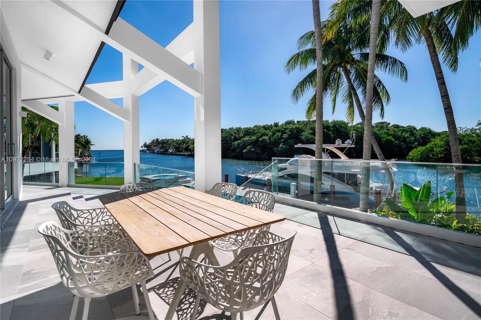 Completely rebuilt with custom chic modern design by Carmen Alcaraz Gomes of CG1 Design. This waterfront home is nestled on a quiet cul-de-sac in the guard-gated community, Sunrise Harbour. Perfectly situated on a SE corner with 189 ft waterfrontage on Coral Gables Waterway, showcasing unobstructed bay views. Deep water and new 120 ft dock easily accommodate a large yacht. Multiple terraces overlook the pool and spa creating intimate entertaining spaces. Interior features include open floor plan, double height ceiling, custom glass encased wine cellar, 3 car garage and elevator. Master suite features two walk-in closets, private balcony, separate shower and jacuzzi for two. Kitchen with Miele appliances, chef’s island, and breakfast nook. Close to parks, shops, eateries, and A+ schools.