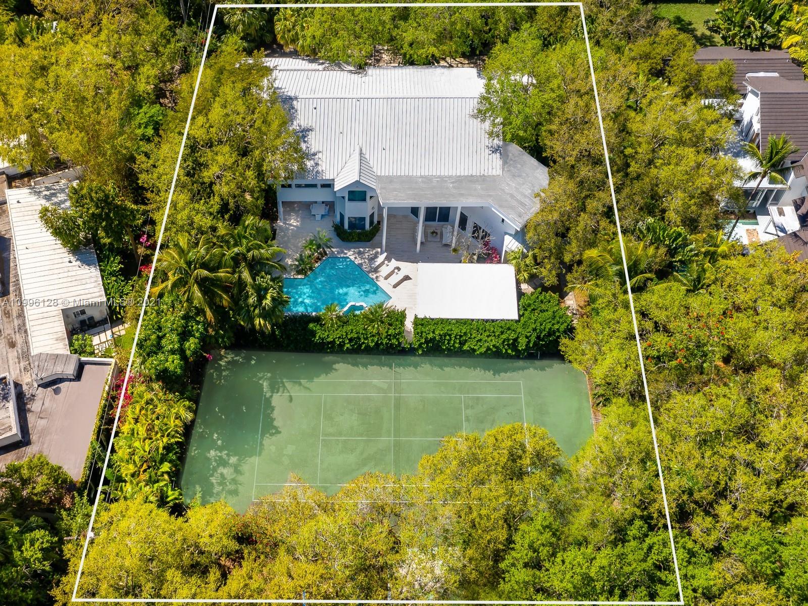 This MODERN Gem sits on nearly on a 38,161SF LOT nestled in a quiet enclave in CORAL GABLES.Take advantage of this unique opportunity to own a completely updated home featuring a tennis/basketball Ct,summer kitchen,pool+expansive garden made for entertaining.This beautiful home features 6 Bds,7 bths inside of its 8196  SF Total,w flr to ceiling windows which provide ample light throughout the house.On the 1st floor offers formal living+dinning room,completely updated kitchen w top of the line wolf appliances+built in Nespresso Machine,office,guest suite,family room.Upstairs offers master suite w oversized his+her closets,+3 adtl bedrooms.Equipped with tin roof,generator,2 car garage+2 carports,impact windows throughout,surround sound+security system,this gated home is a family’s dream!